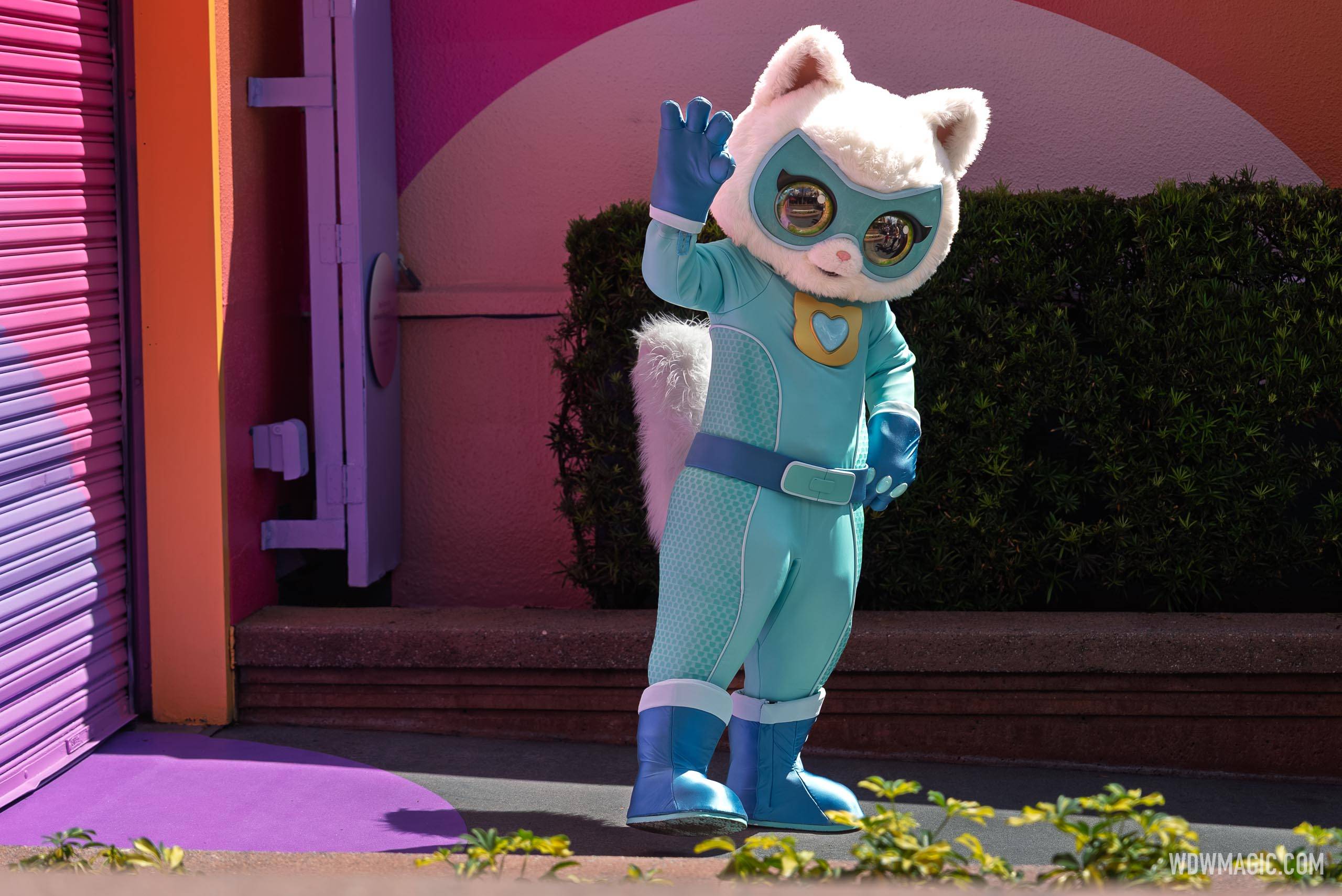 Bitsy waves to guests during the SuperKitties meet and greet on Commissary Lane at Disney's Hollywood Studios