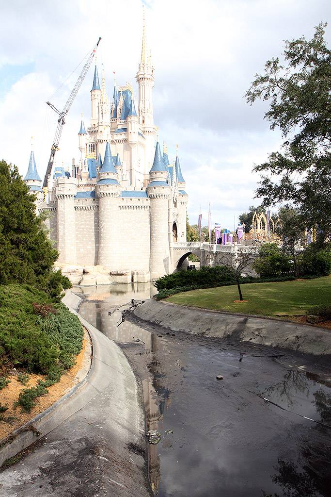 A totally drained castle moat and crane working on the Dream Light removal