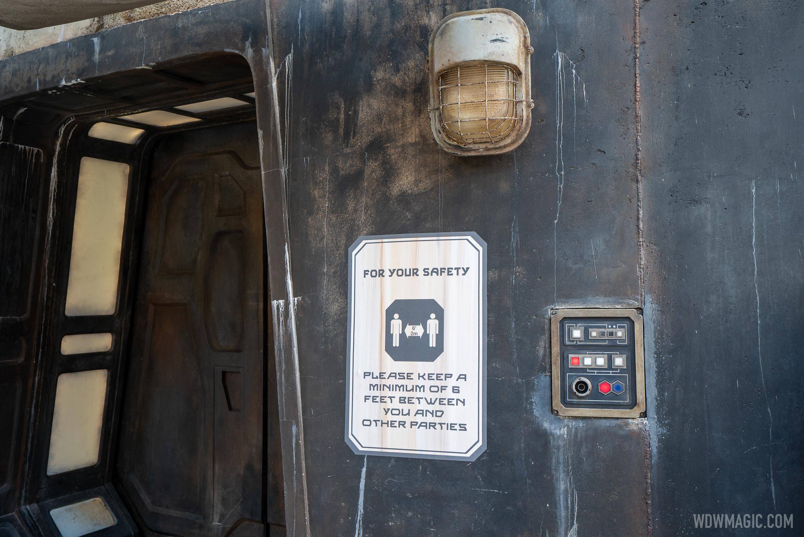 Themed physical distancing safety signs in Galaxy's Edge