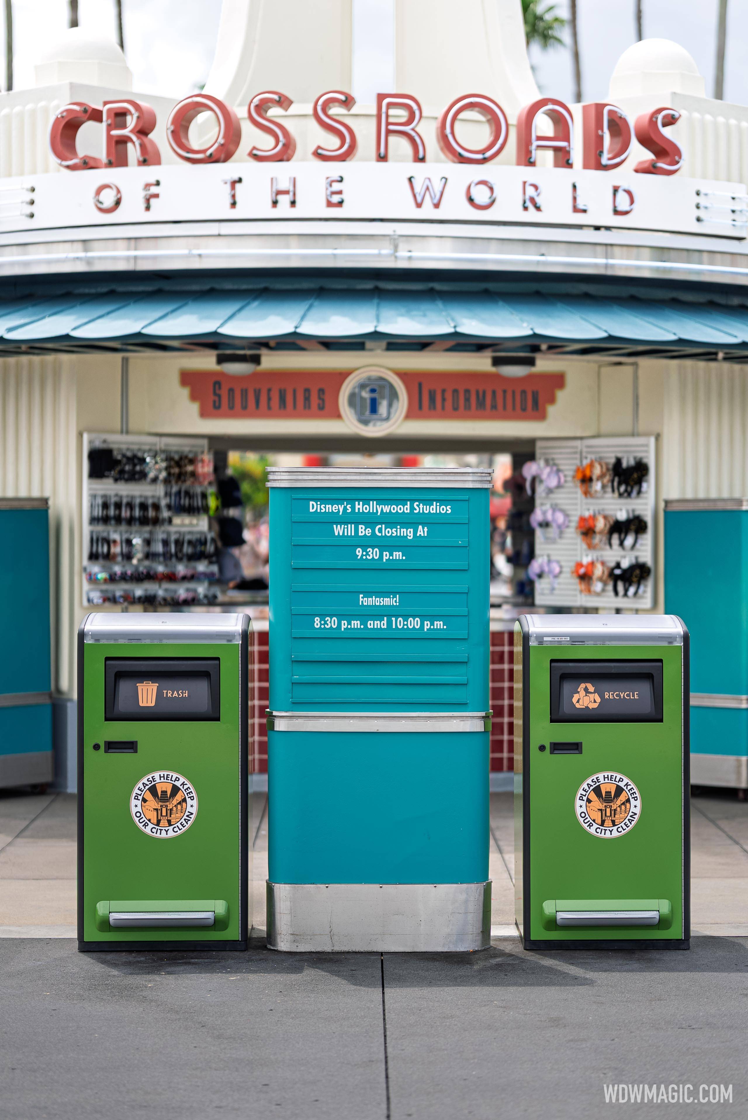 New green solar-powered trash and recycling bins in front of the Crossroads of the World souvenir and information kiosk at Disney's Hollywood Studios