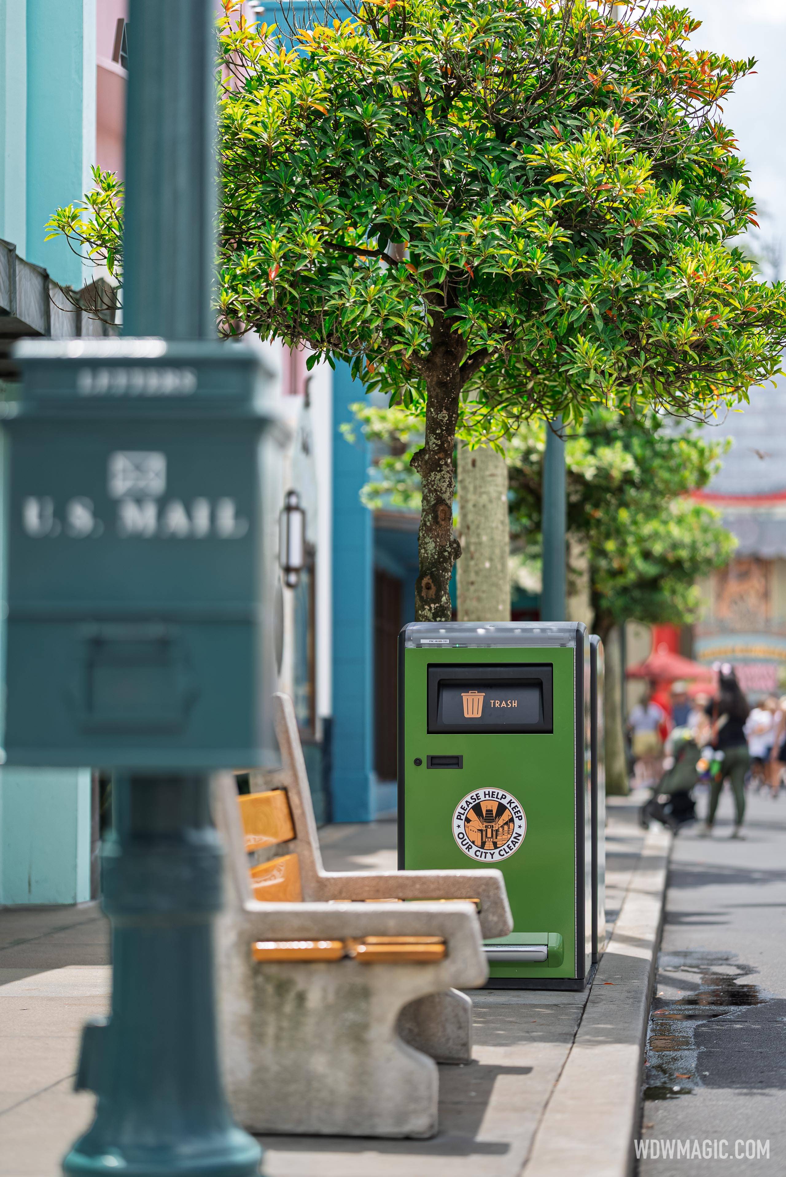 A new green solar-powered trash bin sits alongside a U.S. Mail box and bench on Hollywood Blvd.