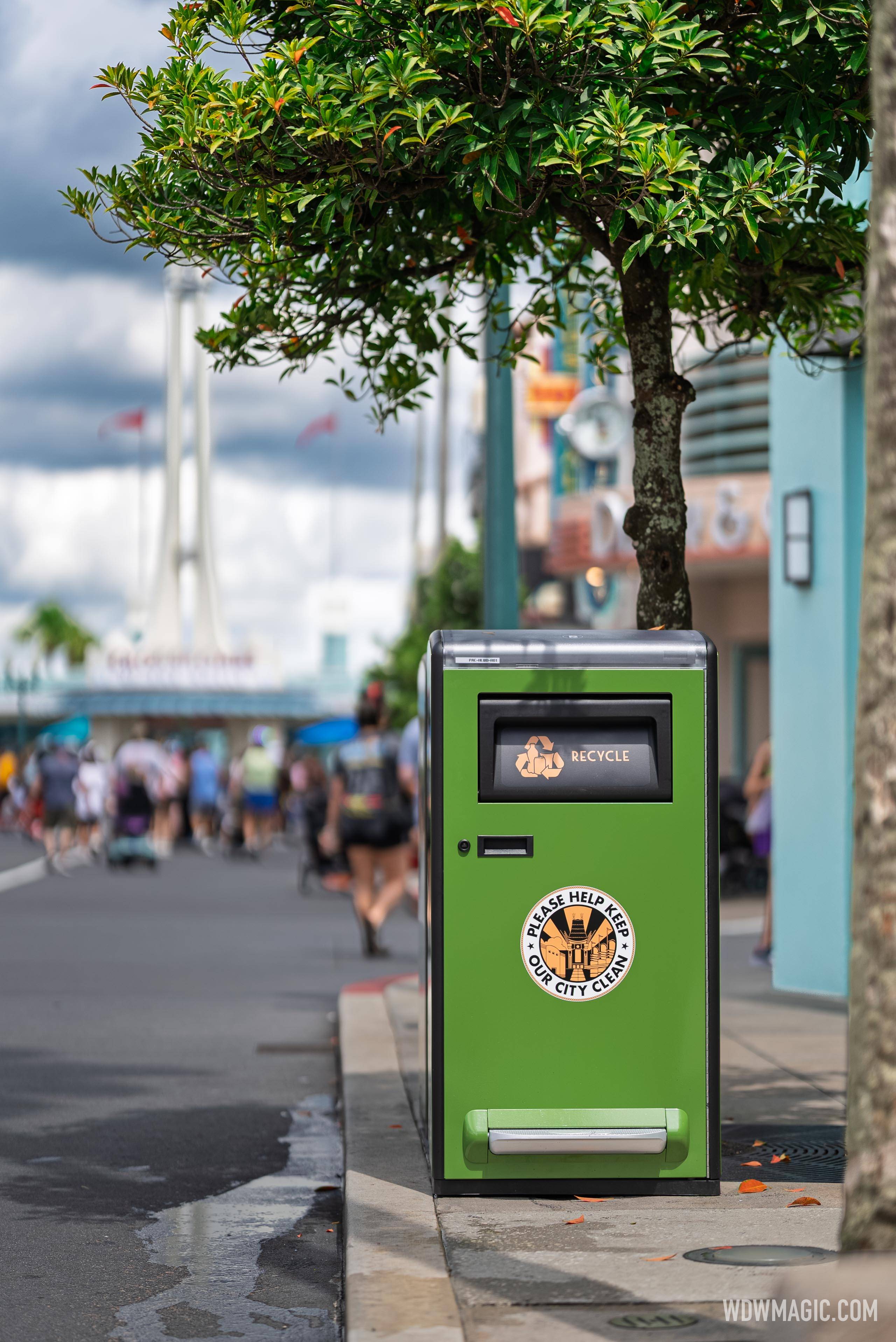 A new green solar-powered recycling bin on Hollywood Blvd. with a "Please Help Keep Our City Clean" decal