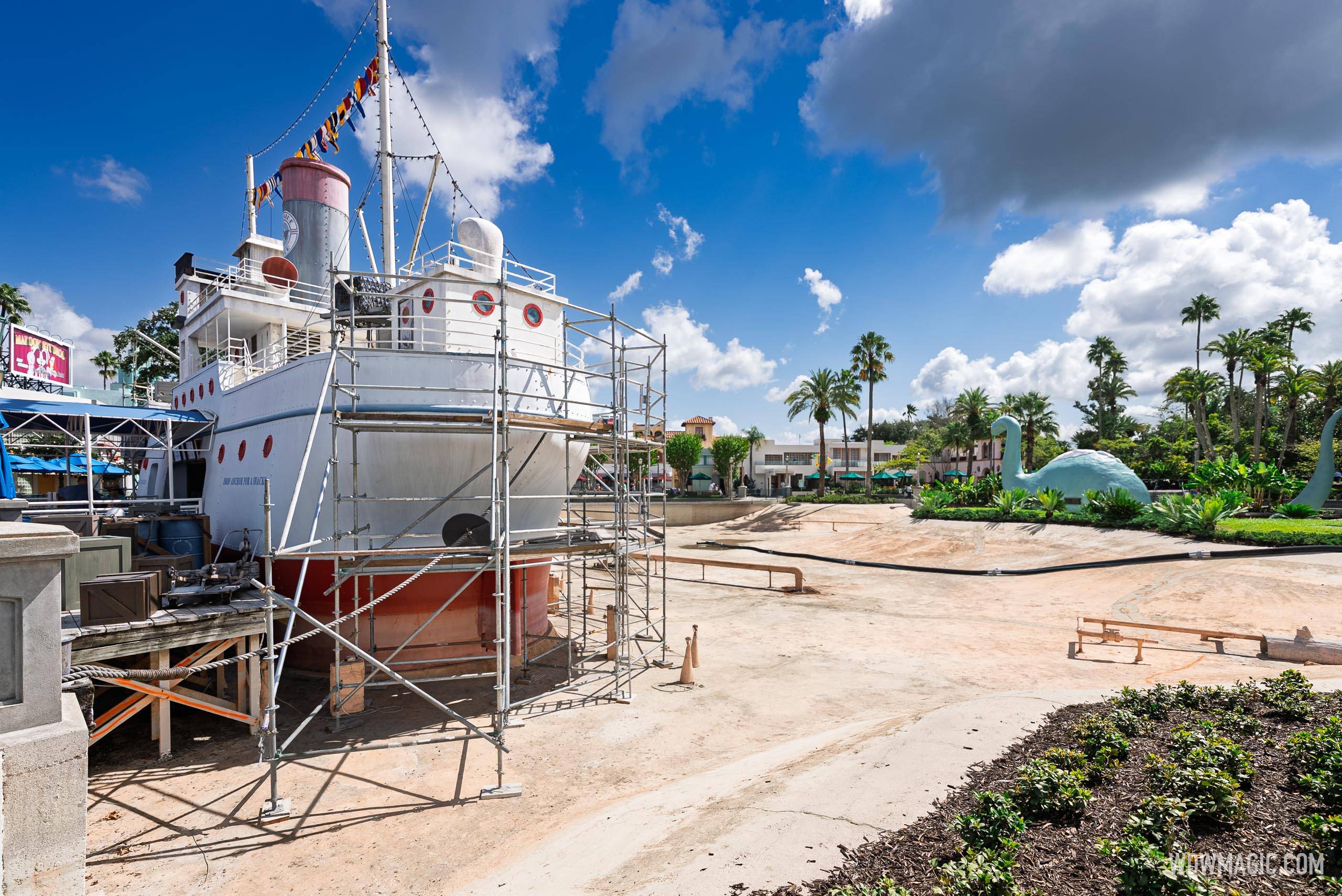 Scaffolding covers the S.S. Down the Hatch vessel as the drained Echo Lake basin sits exposed, with Gertie the dinosaur visible in the background