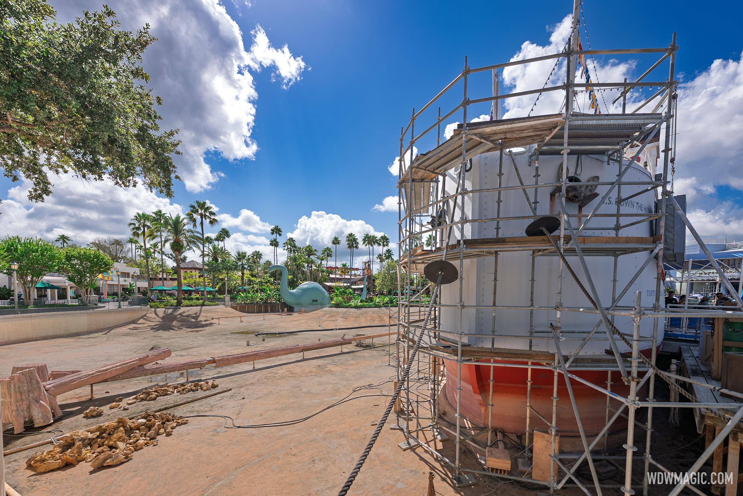 Scaffolding surrounds the S.S. Down the Hatch amid the dry Echo Lake basin, with Gertie the dinosaur and palm trees visible in the background
