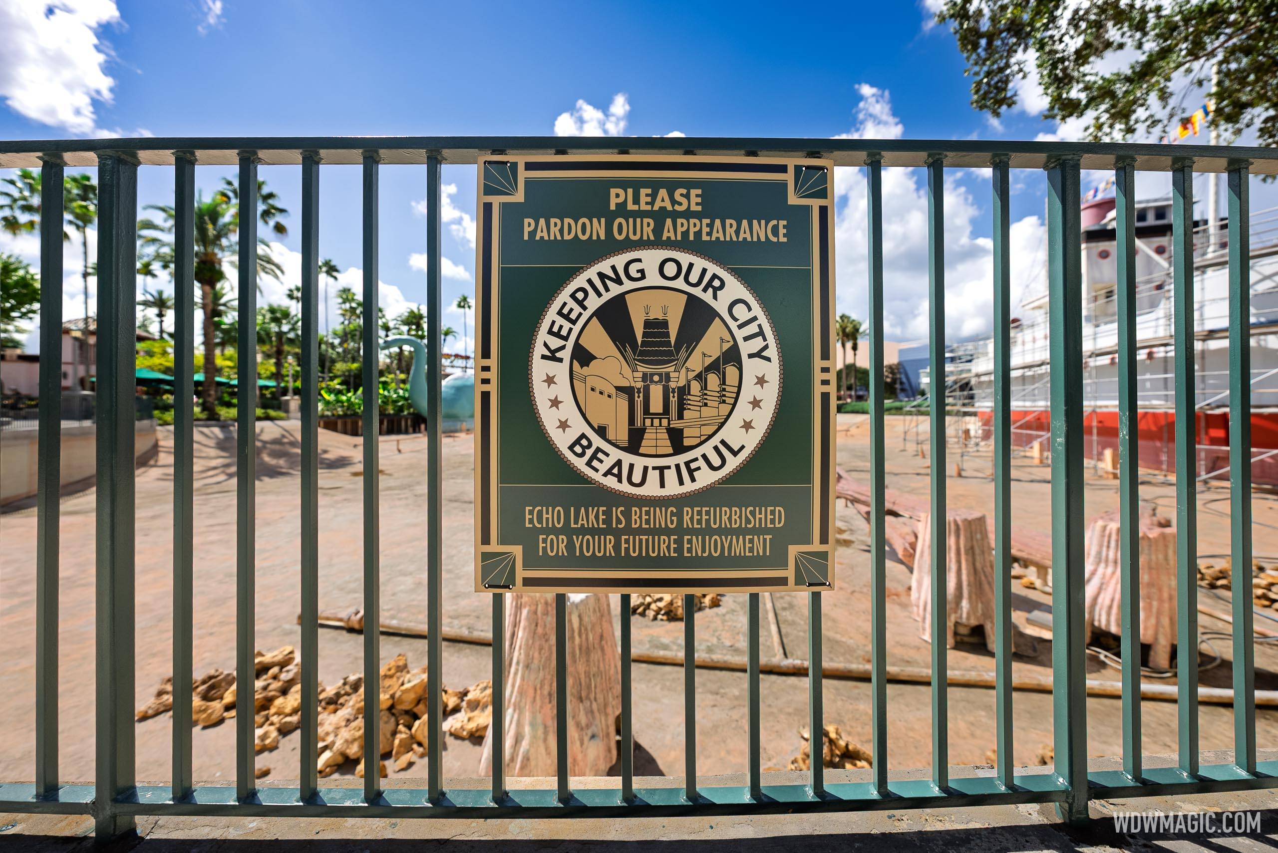 A construction barrier sign reads "Echo Lake is being refurbished for your future enjoyment" with the drained basin and scaffolding-covered S.S. Down the Hatch visible behind it