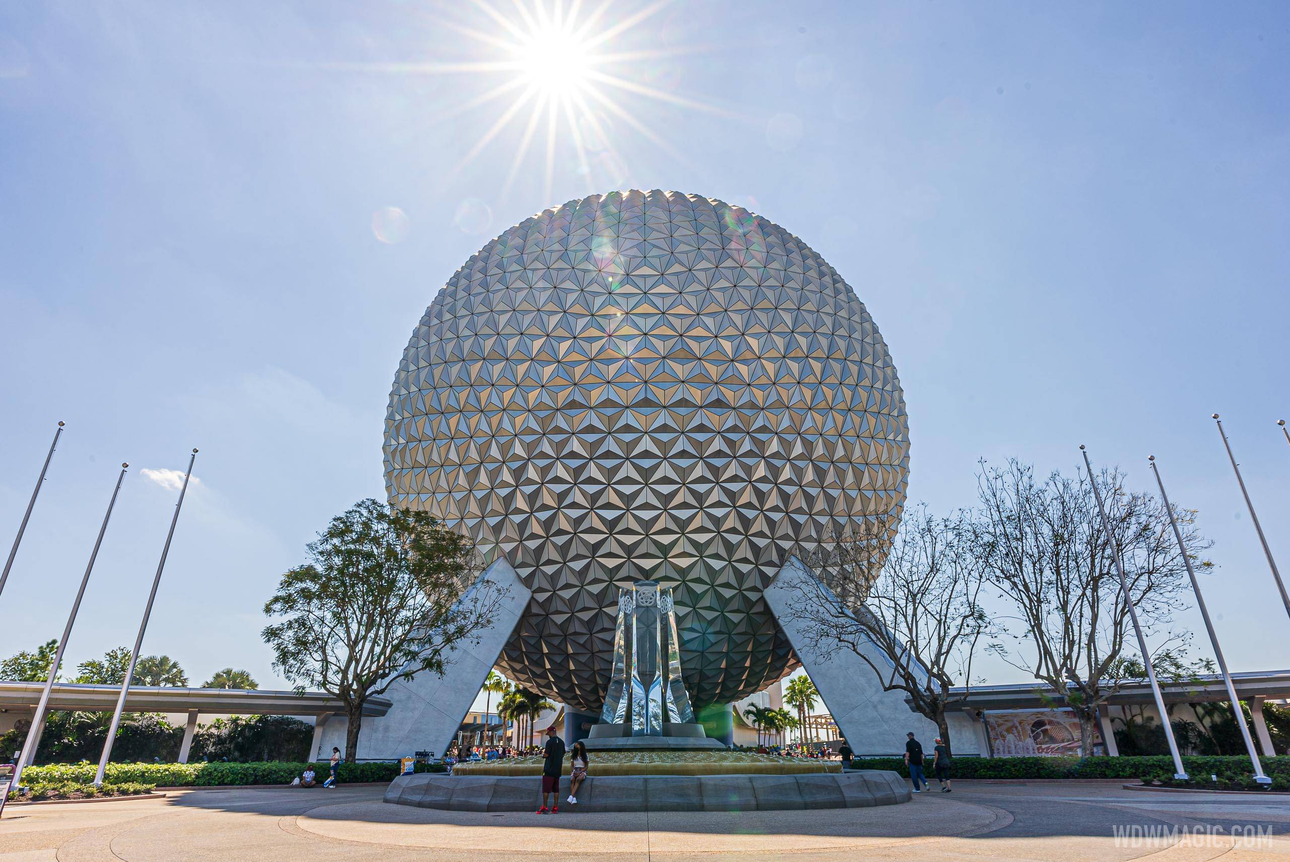 PHOTOS - Western side flag poles installed beside Spaceship Earth as main entrance improvements continue