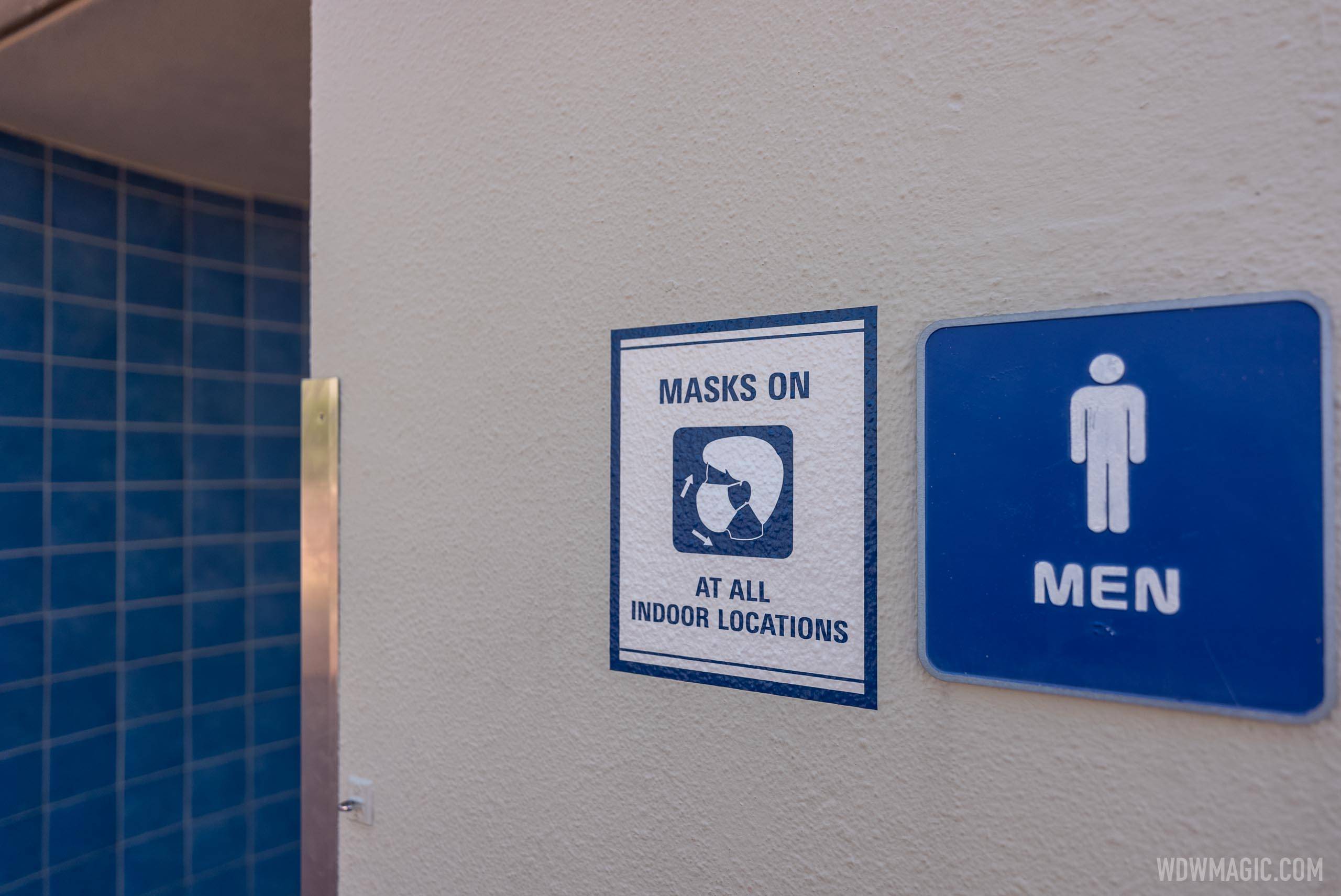 'Masks On' sign outside a restroom in Future World at EPCOT