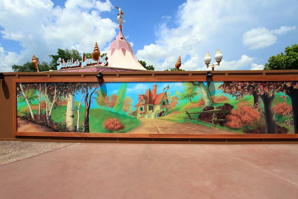 Fantasyland expansion construction walls decorated with large scale 'coming soon' concept art