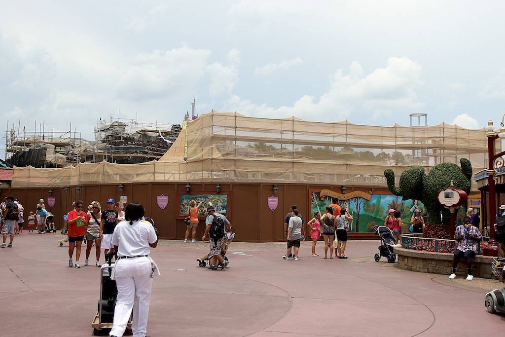 The castle walls rise above the construction wall