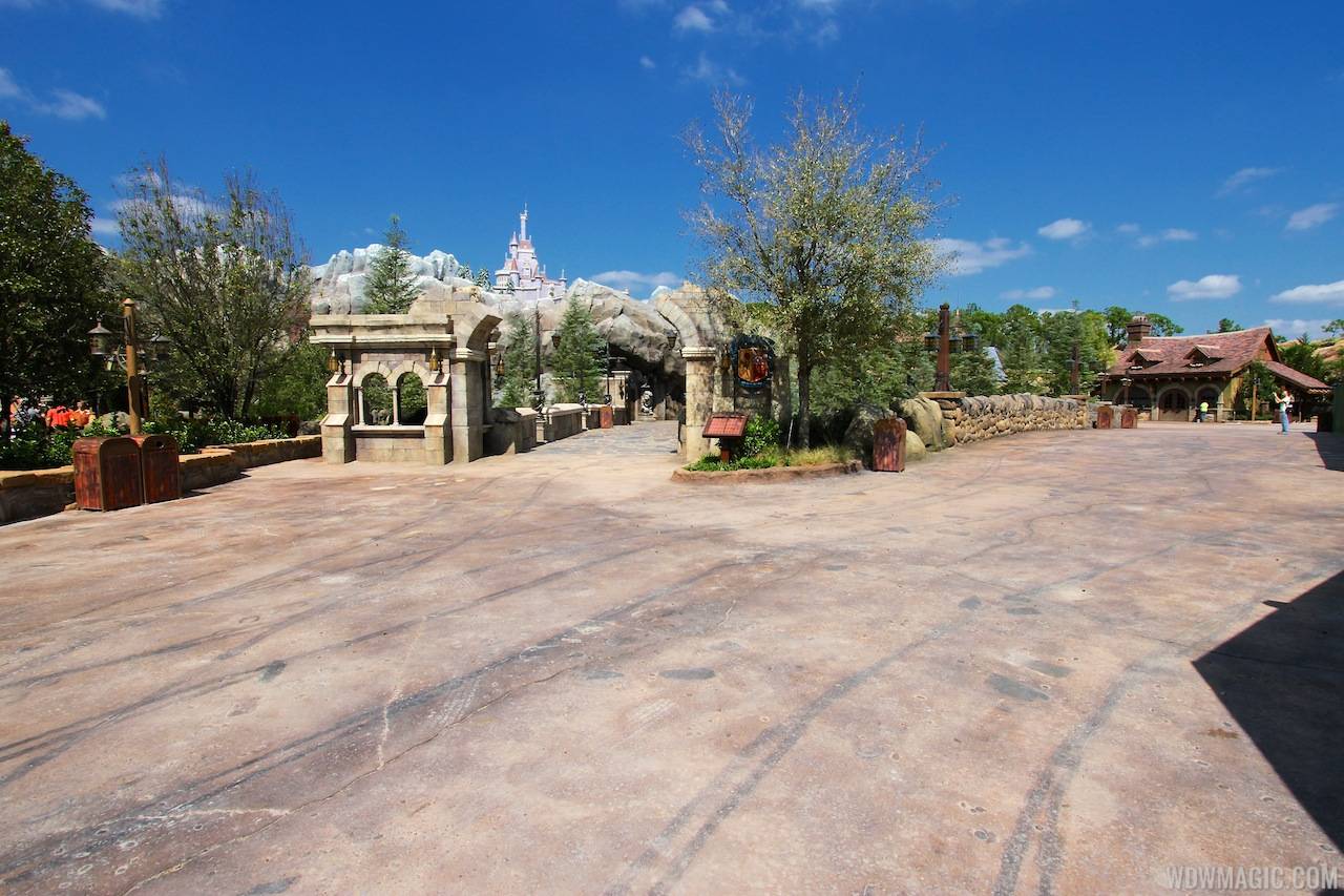 New Fantasyland Enchanted Forest - the entrance to Be Our Guest straight ahead, with Belle's Village to the right with Bonjour Village Gifts