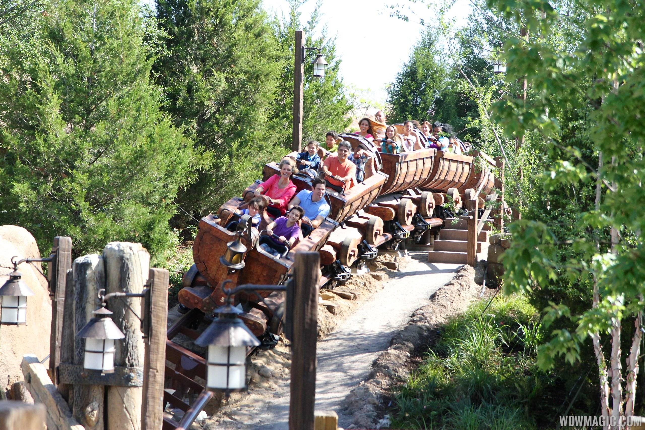 Actors ride the Seven Dwarfs Mine Train coaster