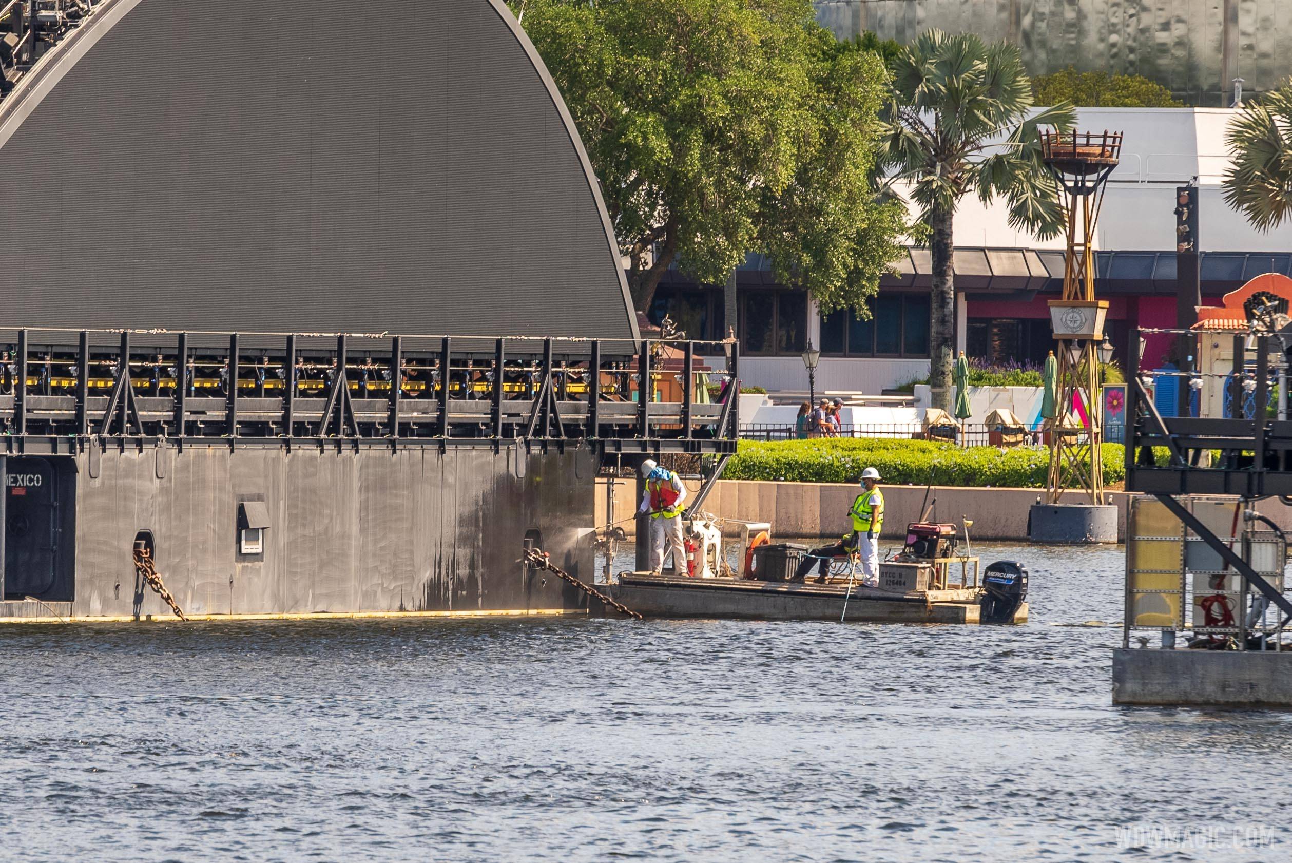 Pressure washing and painting underway on the first of EPCOT Harmonious show platform barges