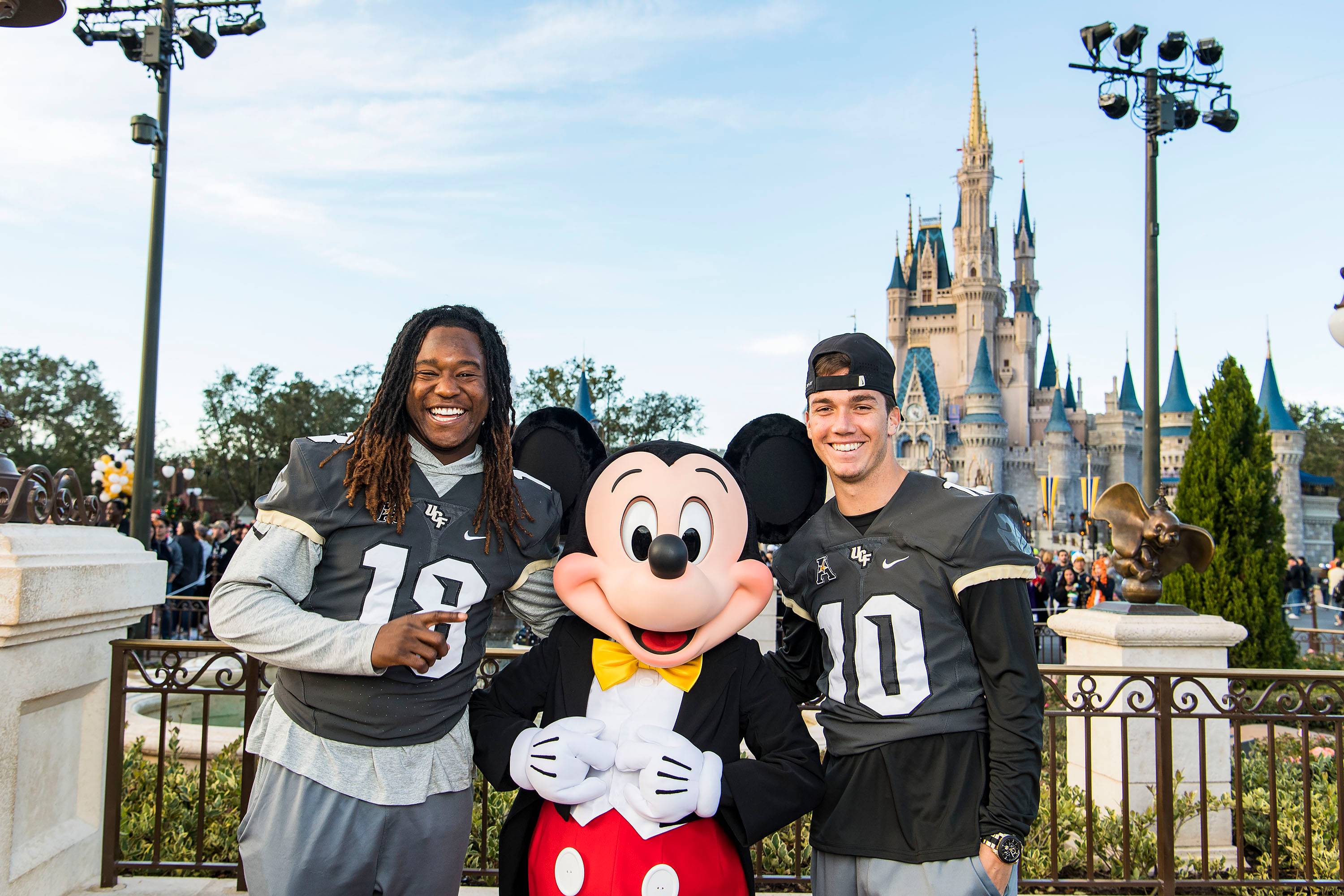 The University of Central Florida Knights linebacker Shaquem Griffin and quarterback McKenzie Milton pose with Mickey Mouse