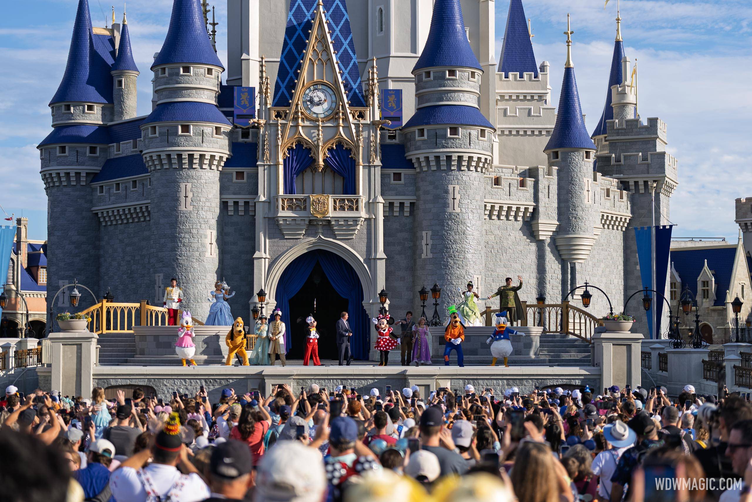 Crowds fill the hub in front of Cinderella Castle as Joe Schott and the Disney character lineup mark Walt Disney World's 55th anniversary on the castle stage