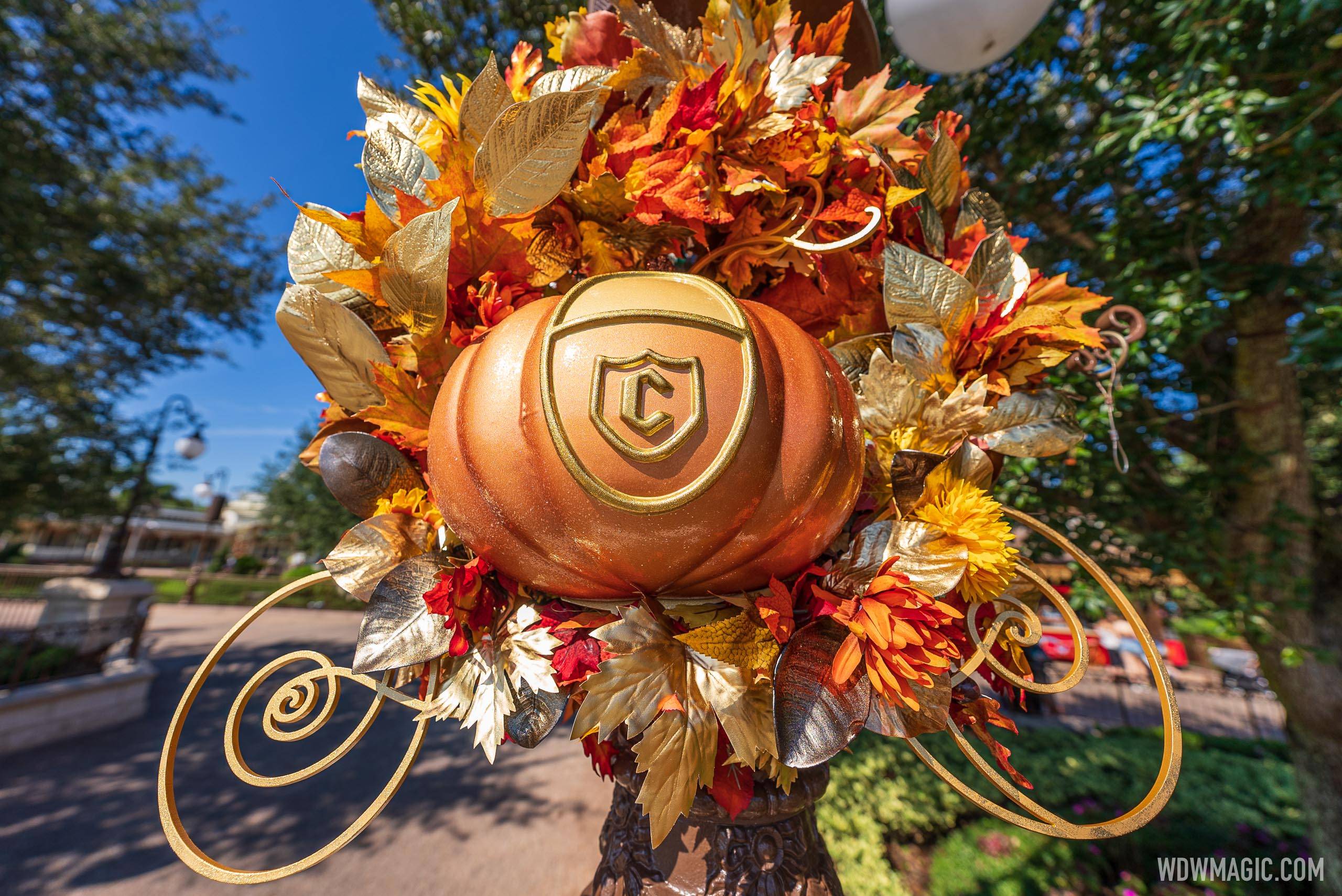 Cinderella Coach pumpkins added to the fall decor at Magic Kingdom