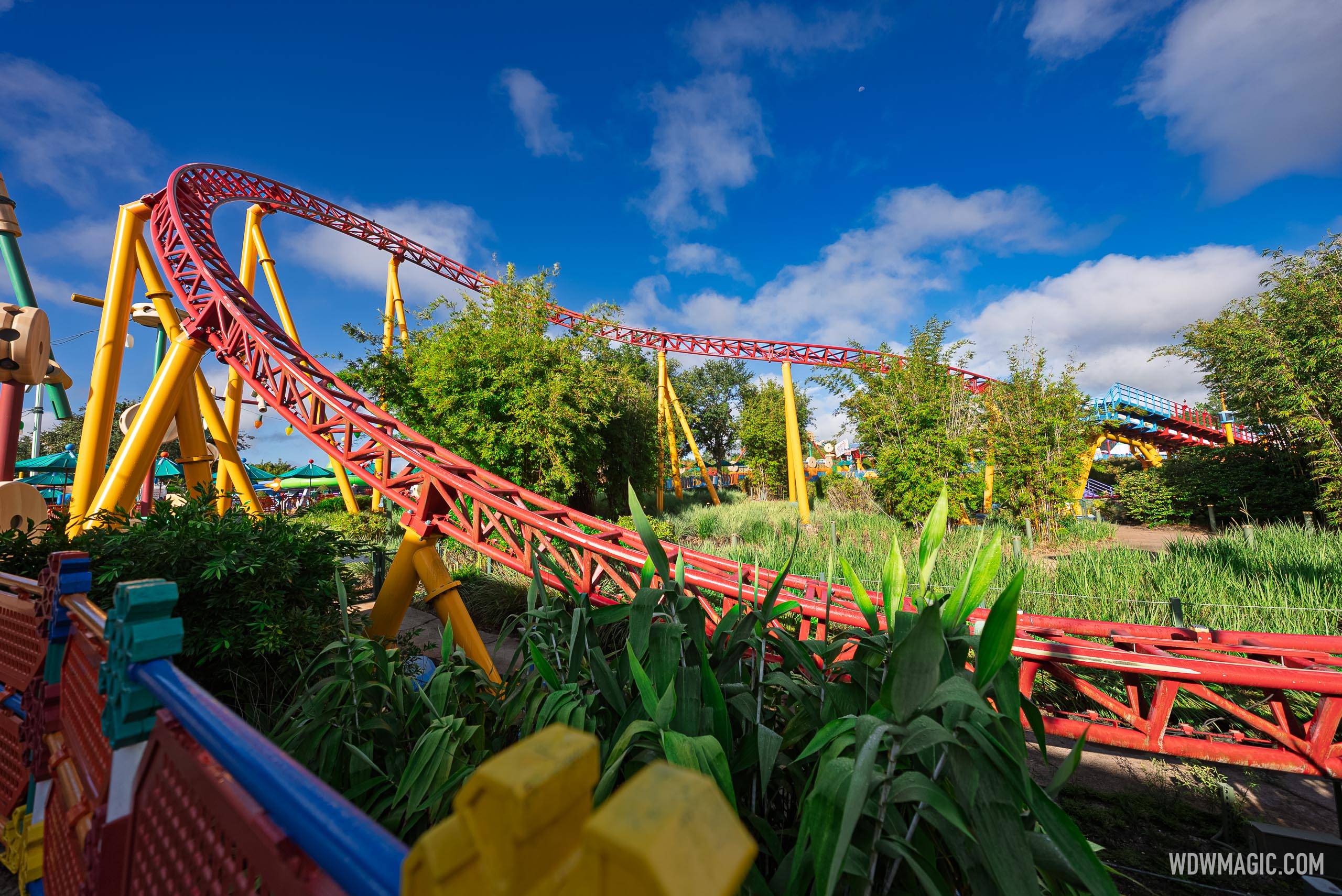 Slinky Dog Dash's red and yellow track winds through Toy Story Land's landscaping