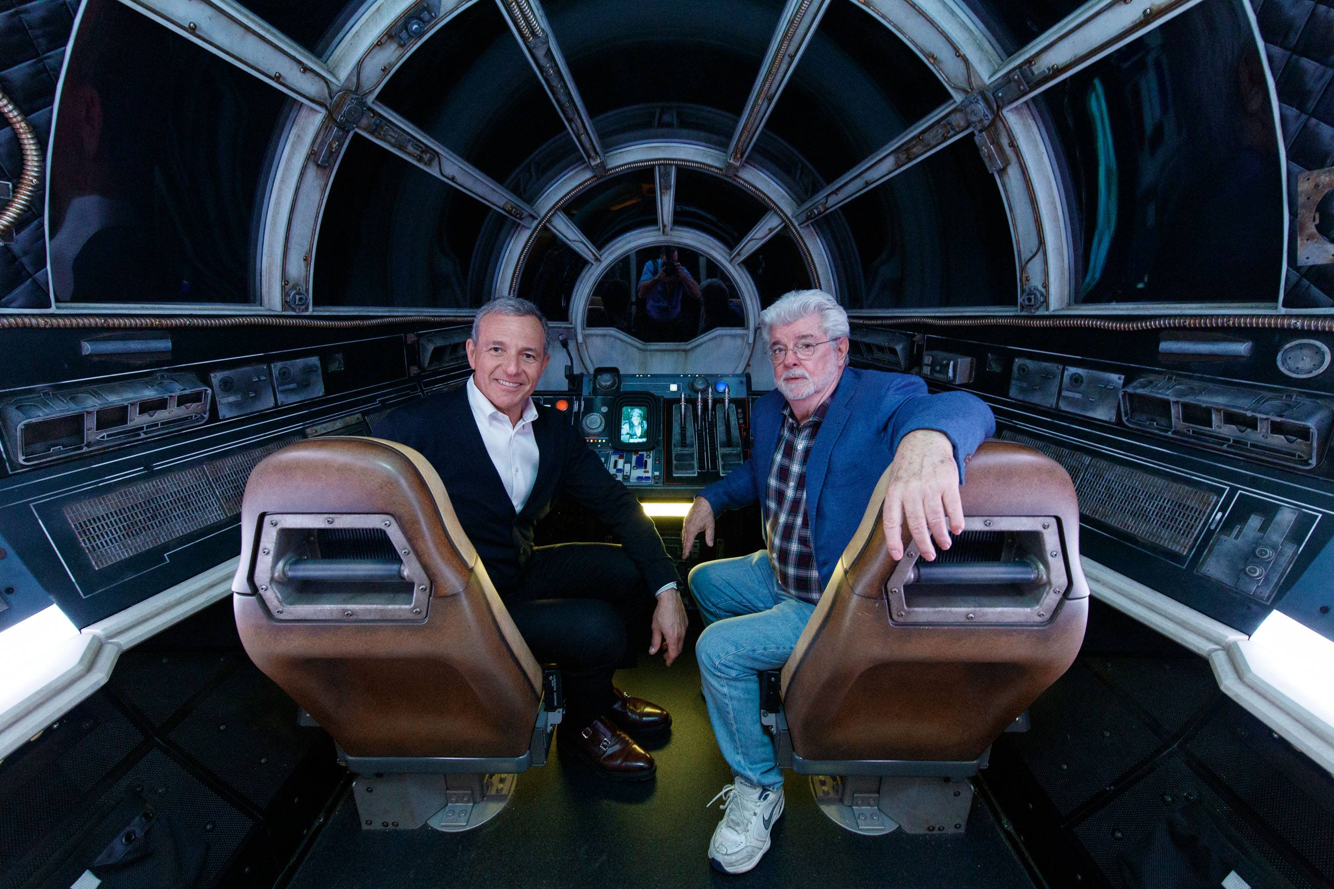 Bob Iger, Walt Disney Company Chairman and CEO (left), and George Lucas, Star Wars creator, pose inside Millennium Falcon: Smugglers Run