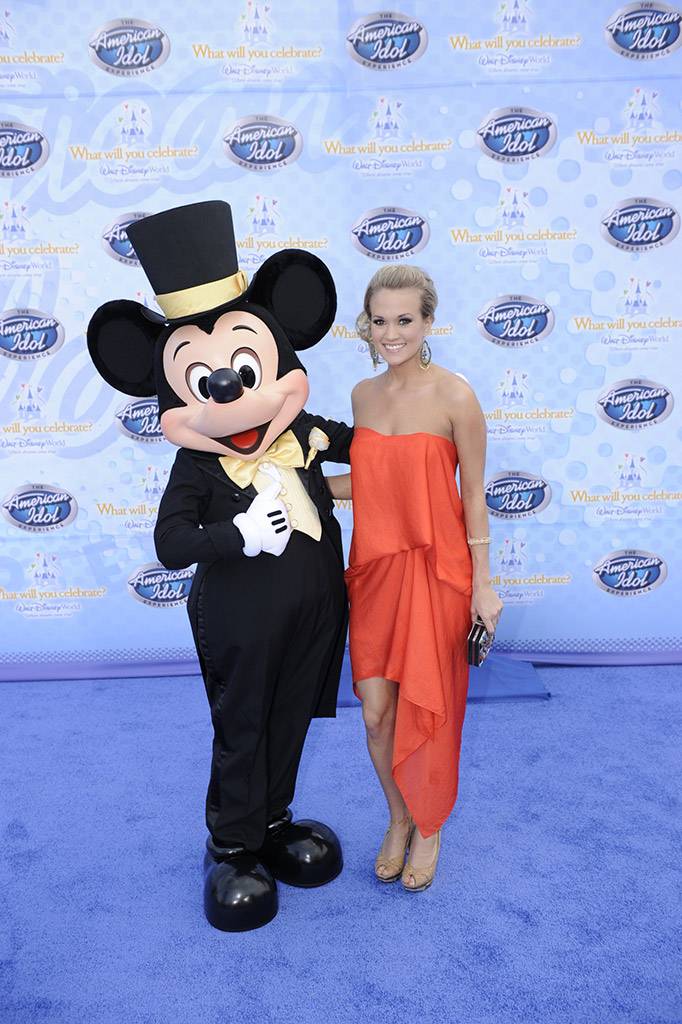 Singer Carrie Underwood, the winner of Season 4 of the hit TV show "American Idol," poses Feb. 12, 2009 with Mickey Mouse during the grand opening of "The American Idol Experience". Photo Copyright The Walt Disney Company 2009.