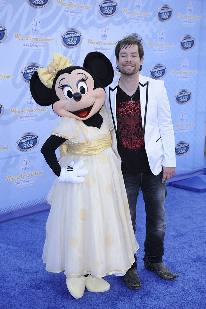 Singer David Cook, the winner of Season 7 of the hit TV show "American Idol," poses Feb. 12, 2009 with Minnie Mouse during the grand opening of "The American Idol Experience" . Photo Copyright The Walt Disney Company 2009.