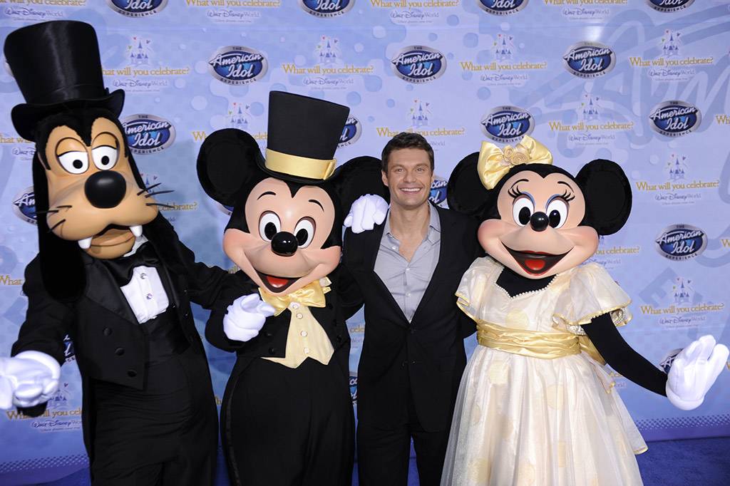 Television and radio personality Ryan Seacrest, the host of the hit TV show "American Idol," poses Feb. 12, 2009 with Goofy, Mickey Mouse and Minnie Mouse during the grand opening of "The American Idol Experience" attraction at Disney's Hollywood Studios. Photo Copyright The Walt Disney Company 2009.