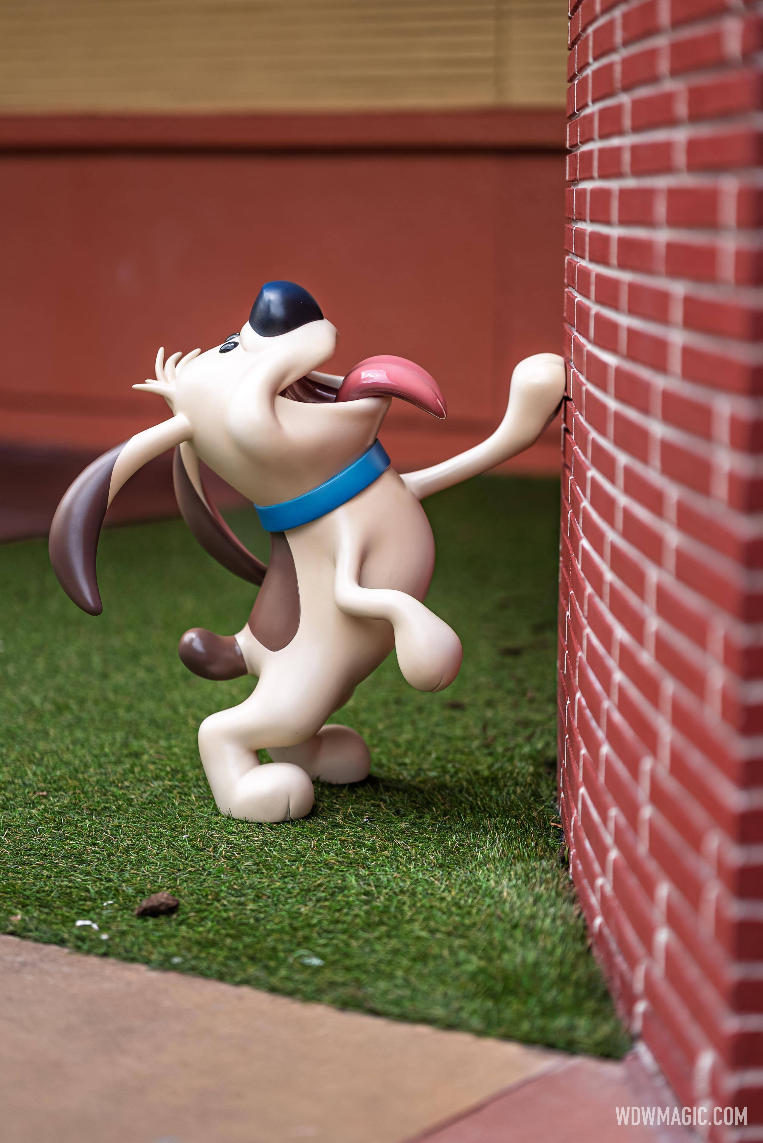 Little Brother from Mulan licks the brick wall in the Walt Disney Studios courtyard outside The Magic of Disney Animation