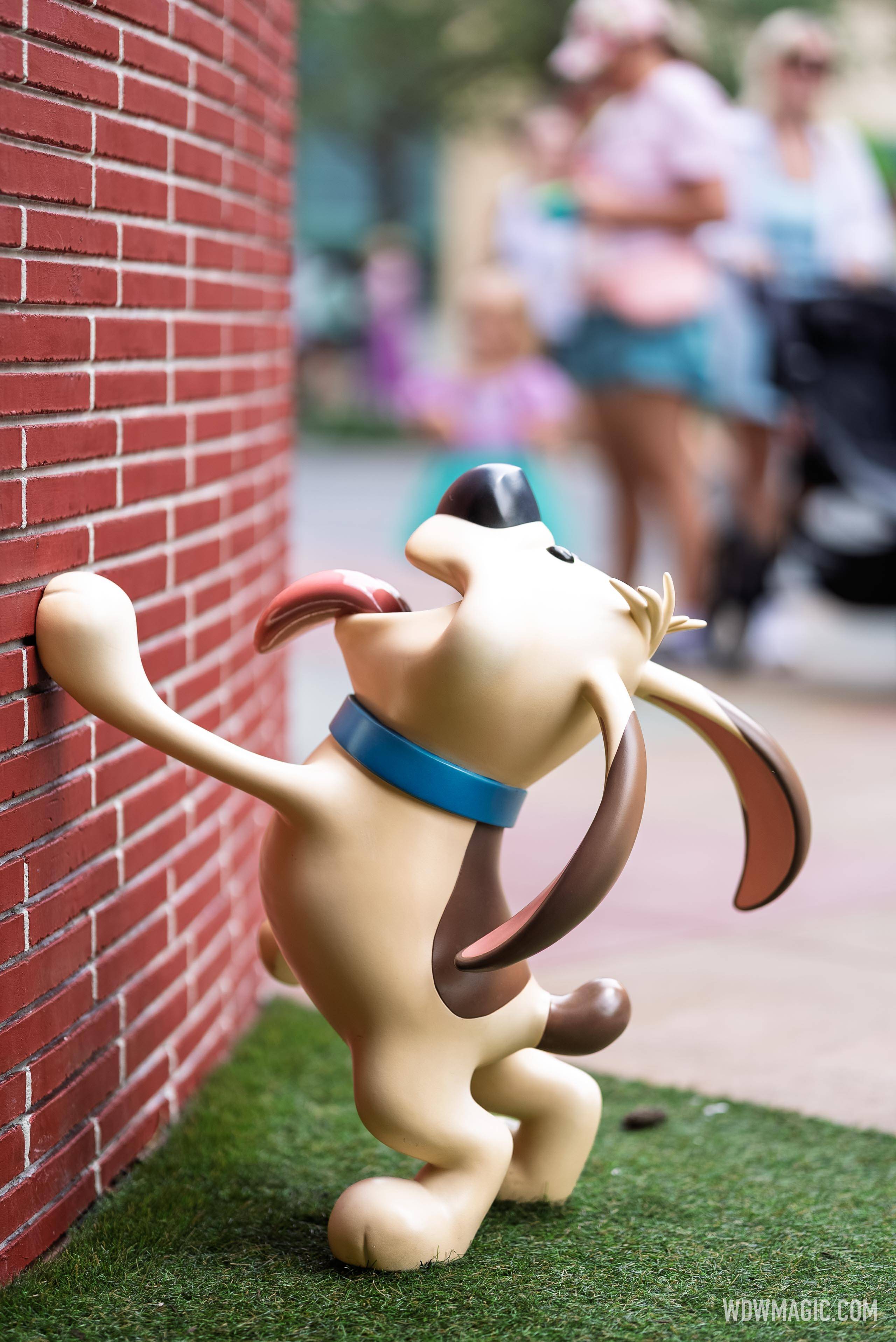 Little Brother from Mulan appears to scratch at a brick wall in the Walt Disney Studios courtyard outside The Magic of Disney Animation