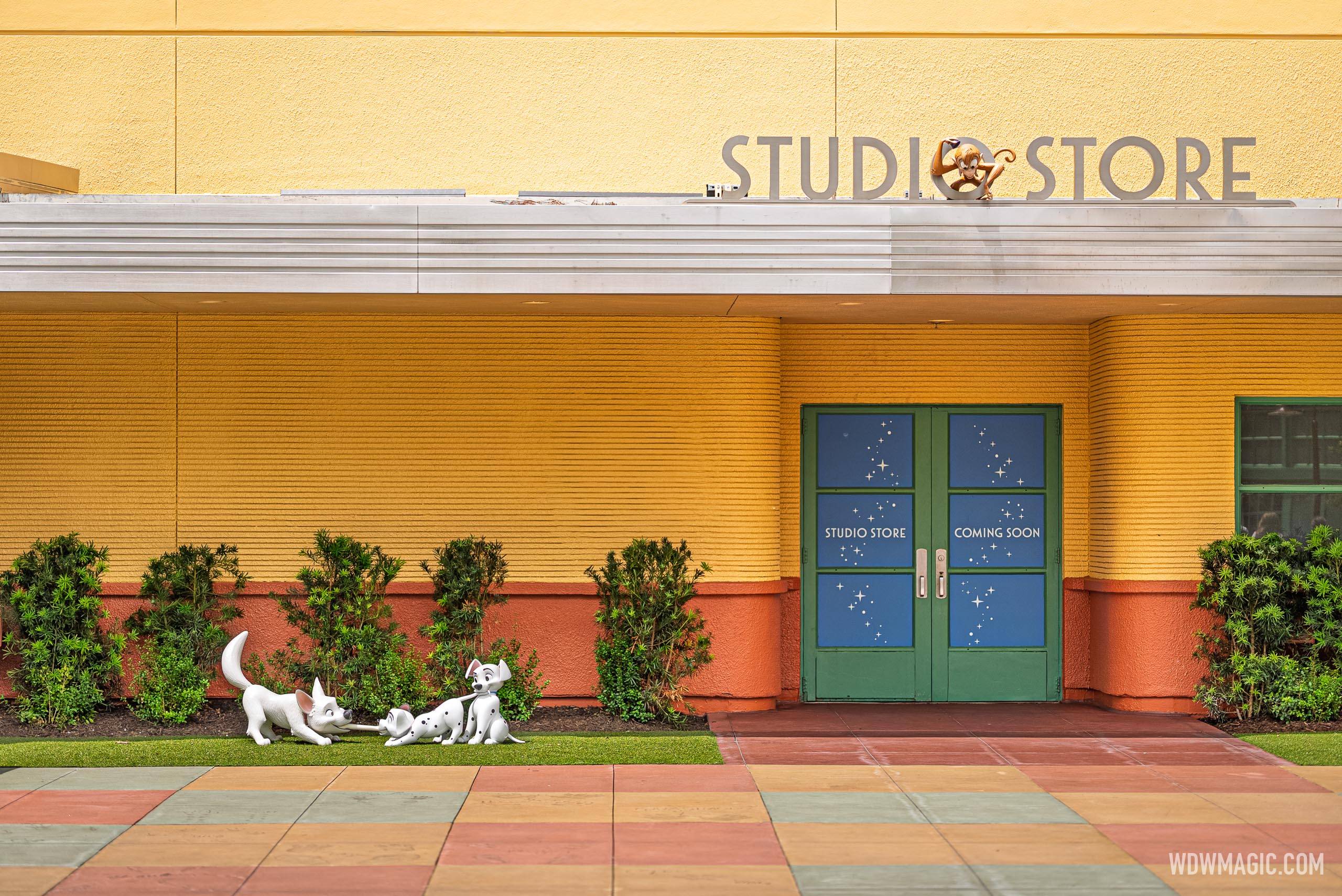 Bolt and two dalmatian puppy statues sit on the grass outside the Studio Store
