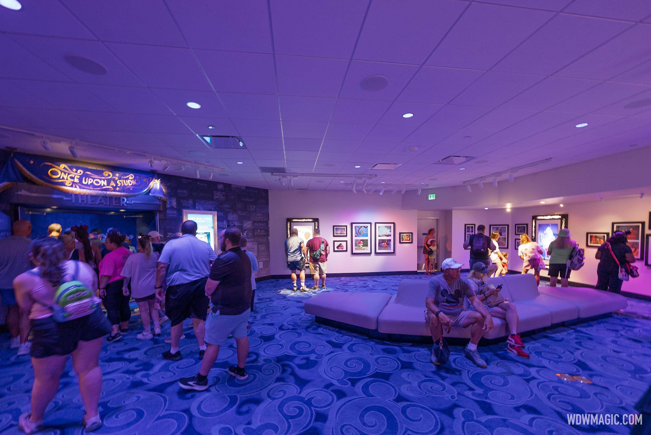 Guests browse the enchanted art gallery inside Magic of Disney Animation, with the Once Upon a Studio Theater entrance visible at left
