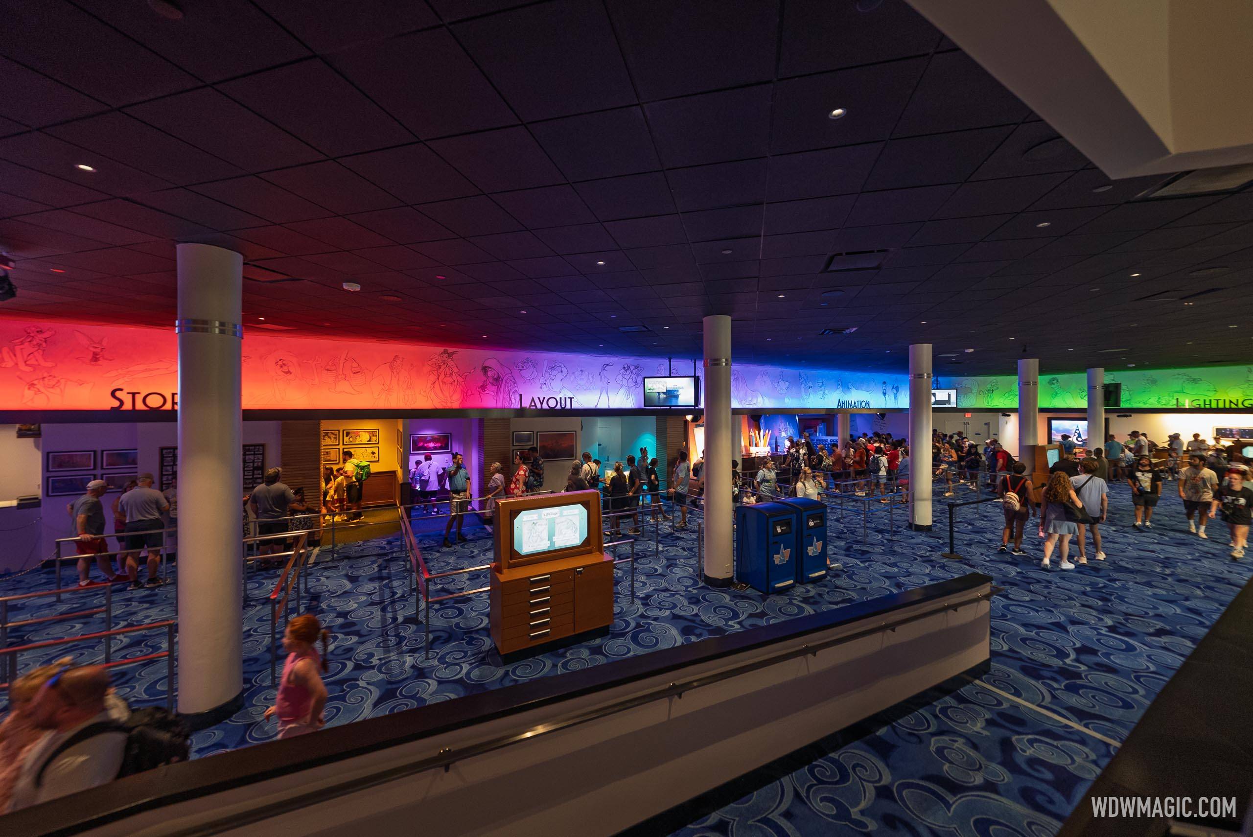 The main lobby of Magic of Disney Animation, with color-coded sections for Story, Layout, Animation, and Lighting visible along the upper walls - each holding a meet and greet