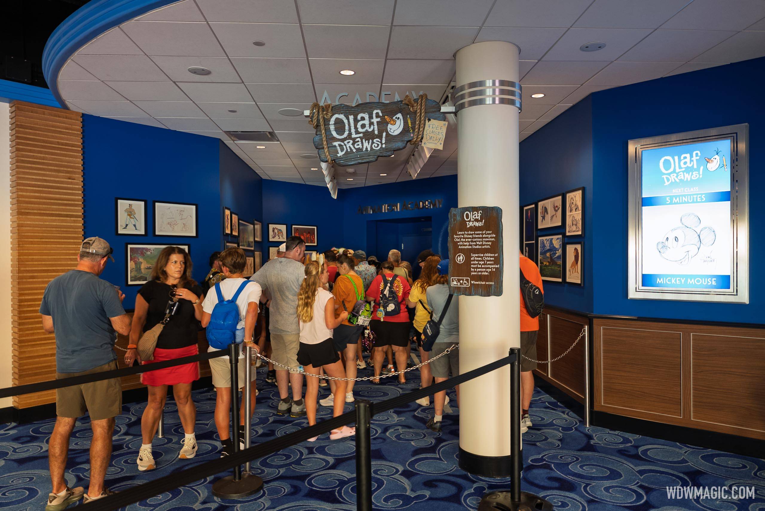 Guests queue for Olaf Draws! inside Magic of Disney Animation, with a sign noting the next class begins in 5 minutes featuring Mickey Mouse
