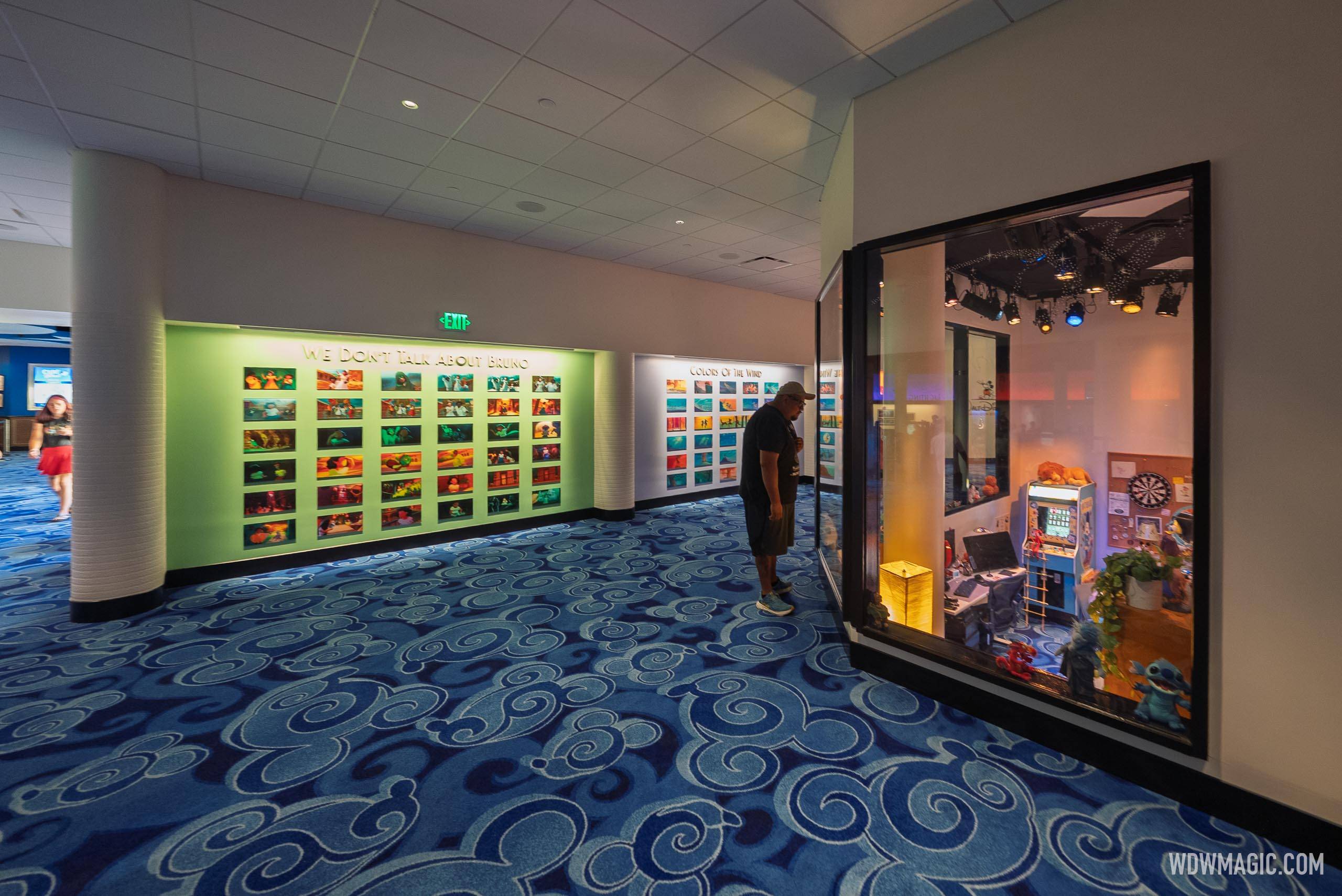 The enchanted art gallery corridor displays color storyboards for "We Don't Talk About Bruno" and "Colors of the Wind"