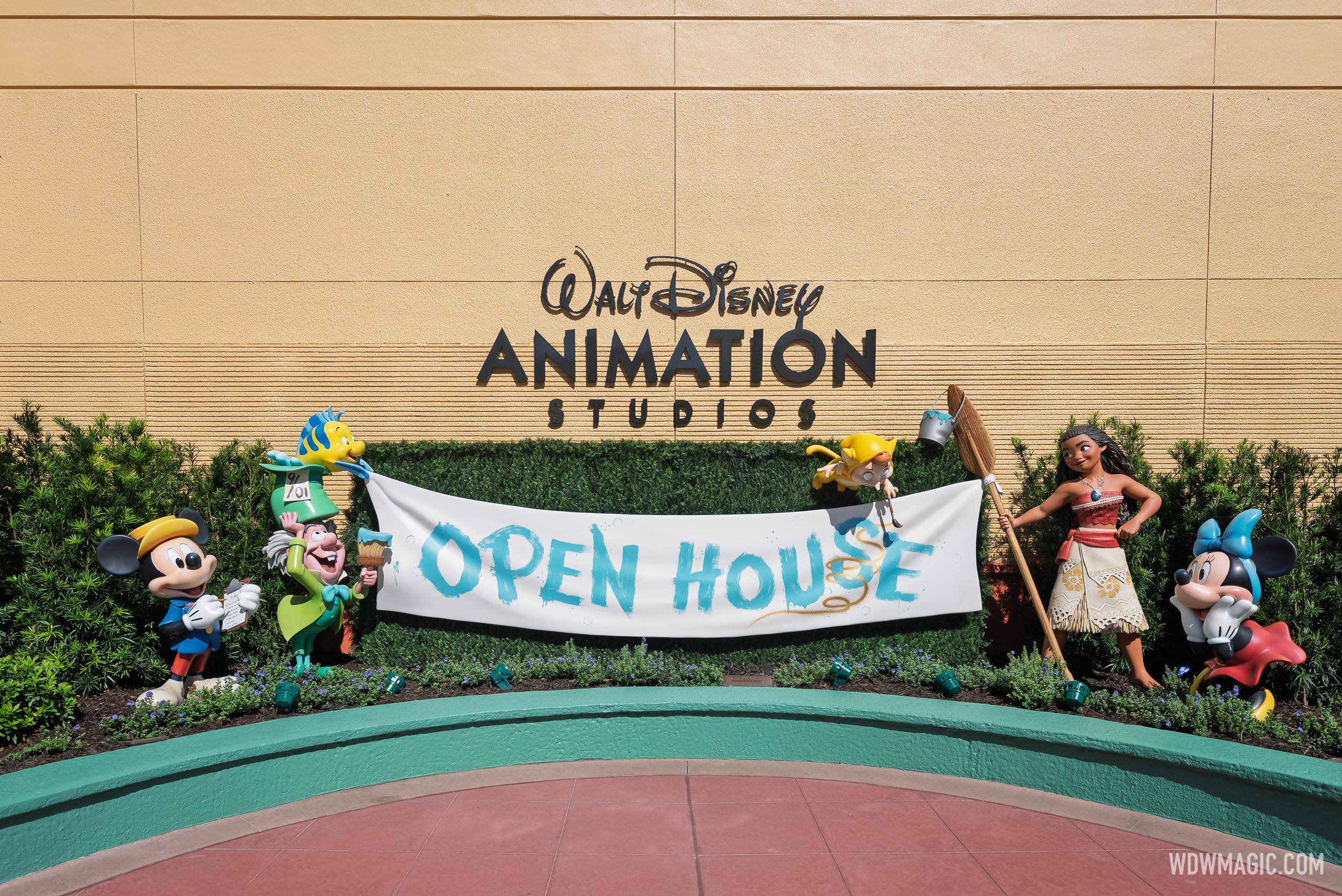 An "Open House" banner is held by statues of Mickey, Minnie, Moana, and other Disney characters in the Walt Disney Animation Studios courtyard