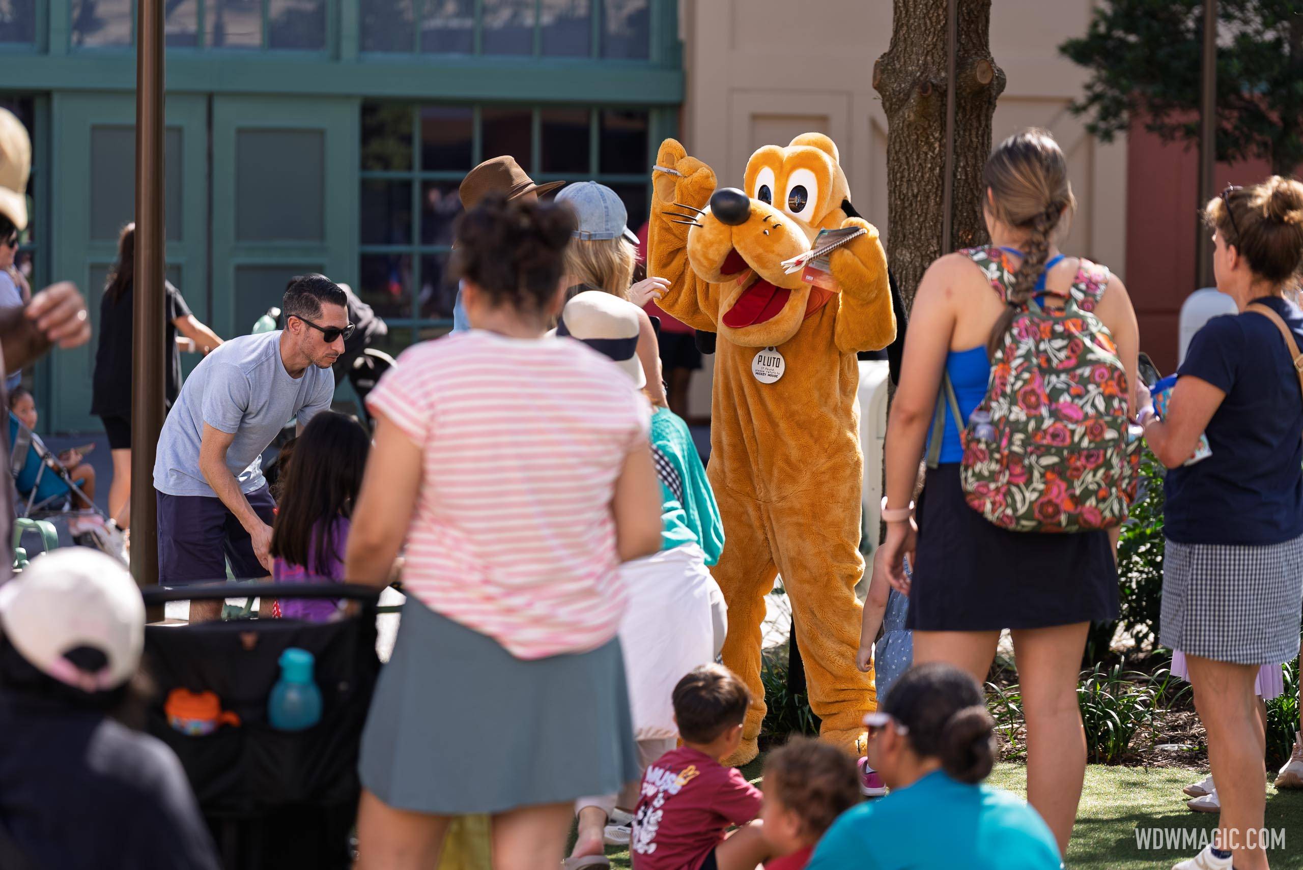 Pluto meets guests in the Walt Disney Studios courtyard outside Magic of Disney Animation