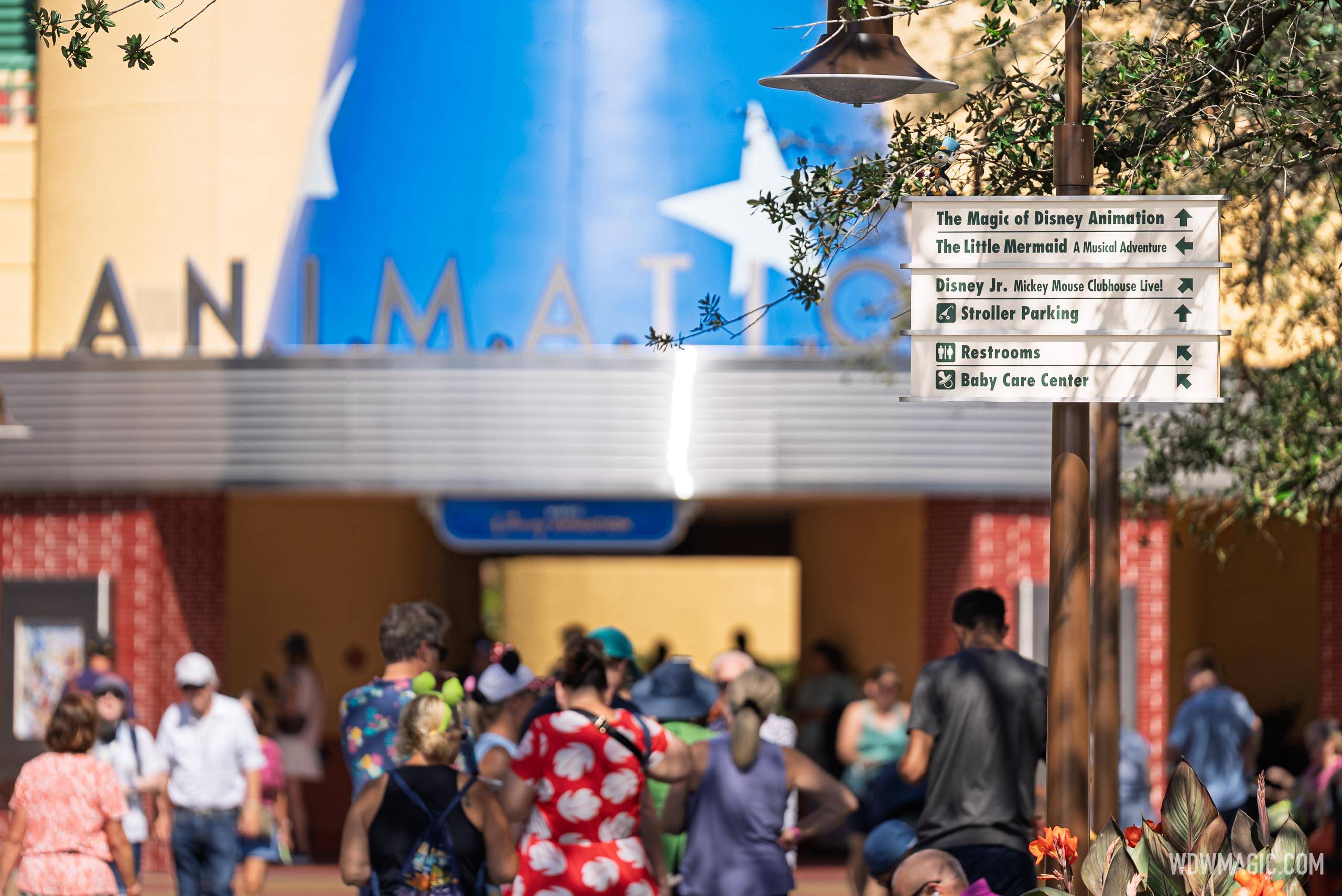 Directional signage outside Magic of Disney Animation points guests toward The Little Mermaid: A Musical Adventure, Disney Jr. Mickey Mouse Clubhouse Live!, stroller parking, restrooms, and the Baby Care Center