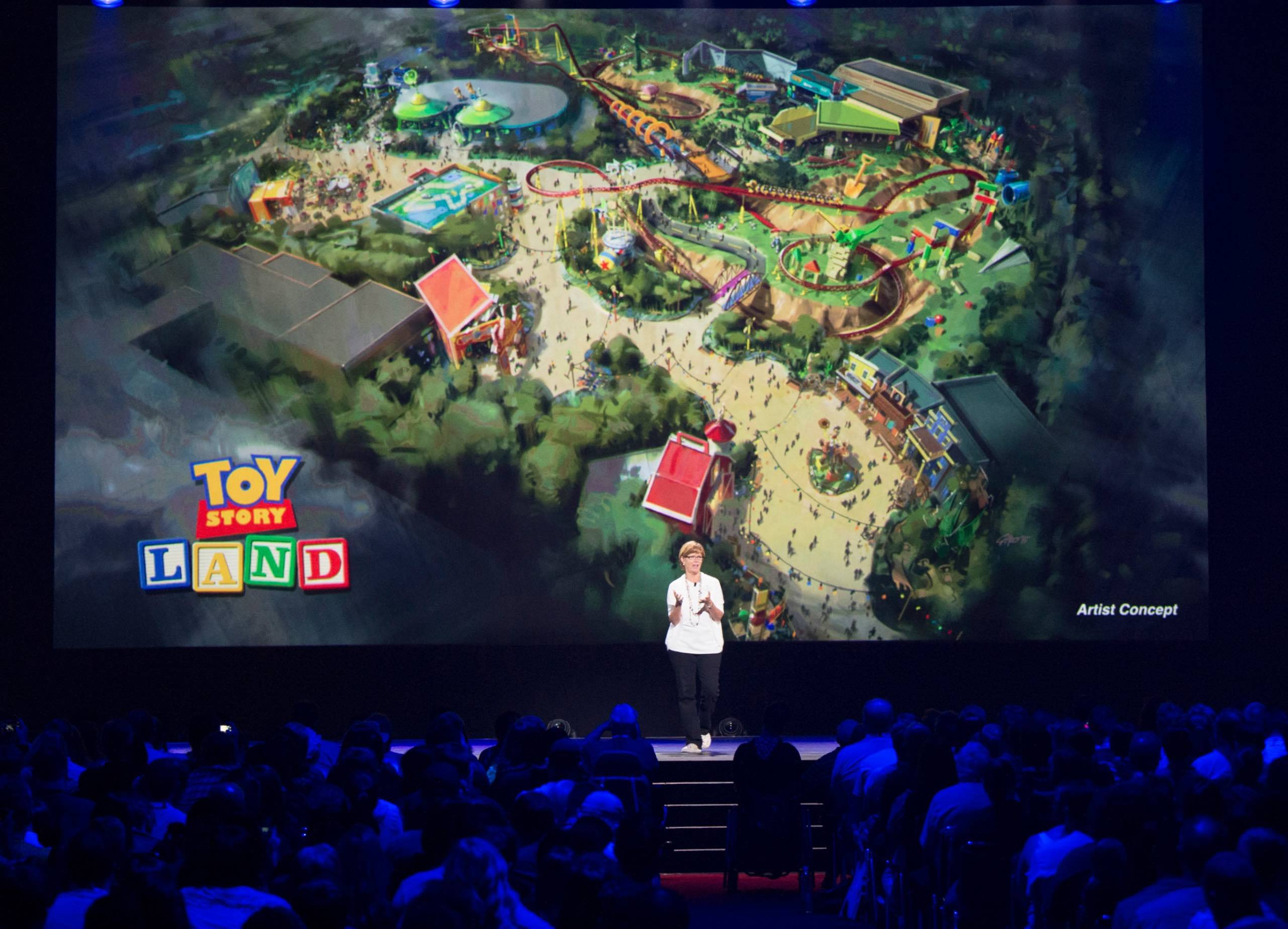 Imagineer Kathy Mangum showing Toy Story Land concept art at D23