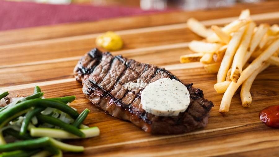 Be Our Guest Restaurant menu item - Grilled Strip Steak with garlic-herb butter and pommes frites