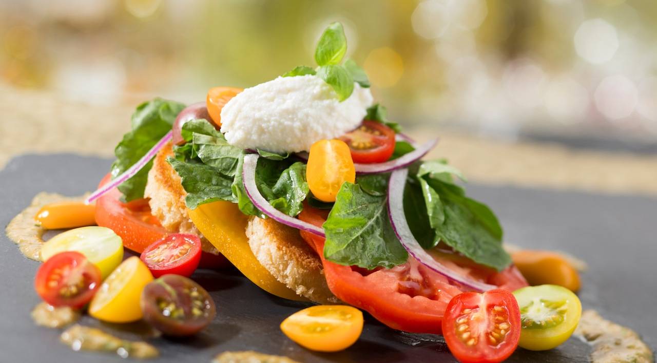 New California Grill menu - Heirloom tomatoes with grilled bread, baby basil, ricotta cheese and vinaigrette flavored with roasted shishito peppers