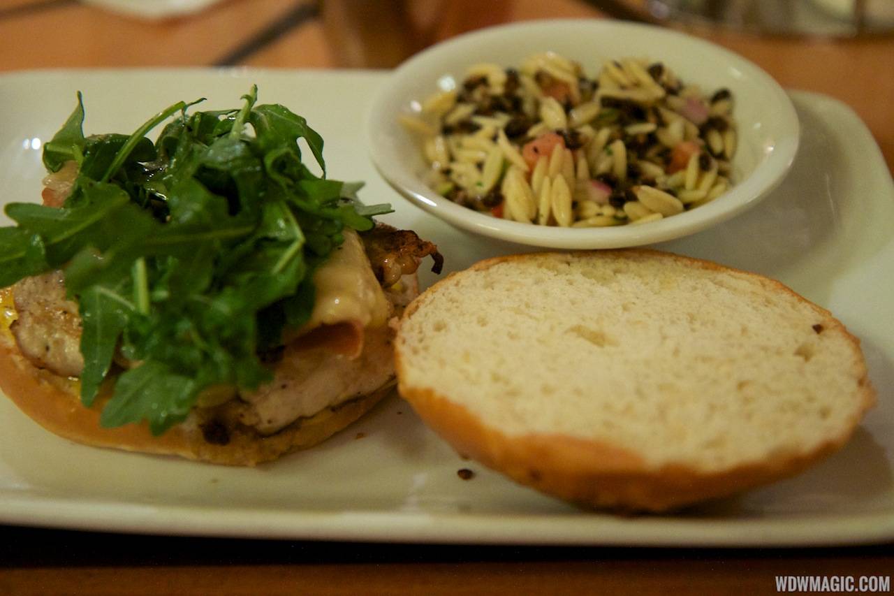 Captain's Grille - Grilled Chicken Sandwich Prosciutto, Aged Vermont Cheddar, and Arugula Salad on a House-made Onion Roll with Vegetable Orzo Salad
