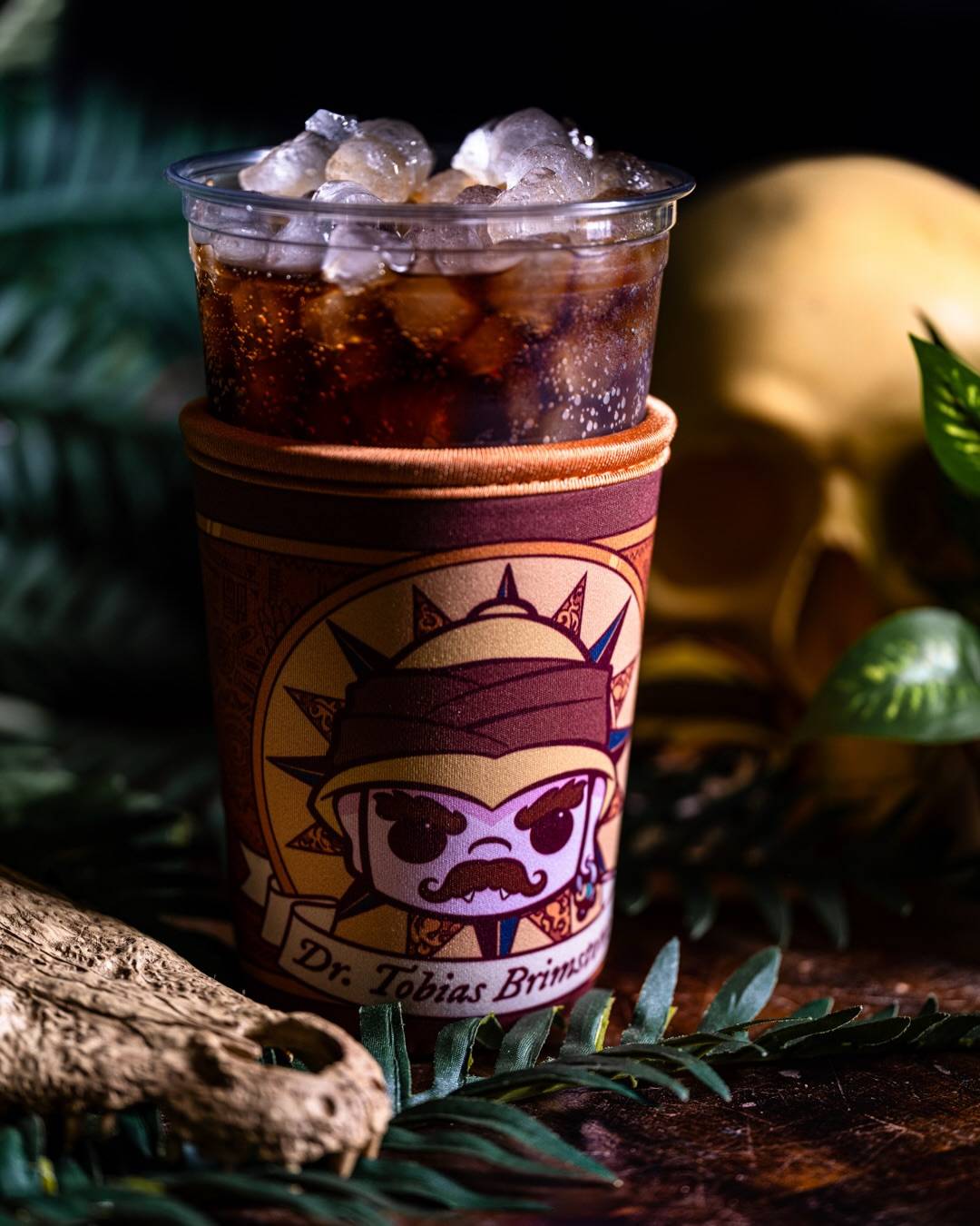 The returning Pumpkin Chai Nitro Cold Brew, served in a Dr. Tobias Brimstone branded cup sleeve