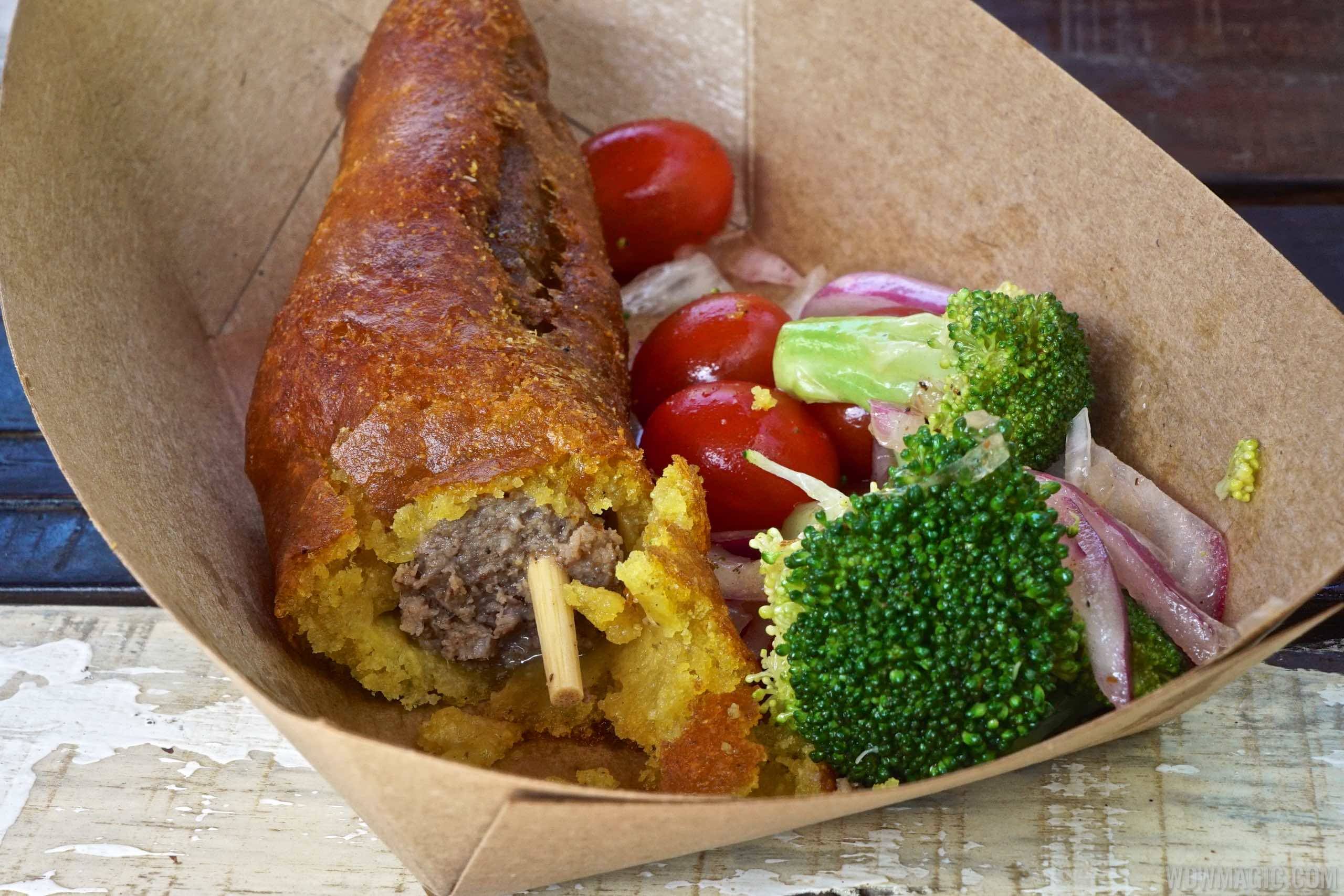 Harambe Market Food - Sausage fried in curried corn batter with roasted broccoli and tomato salad $8.99