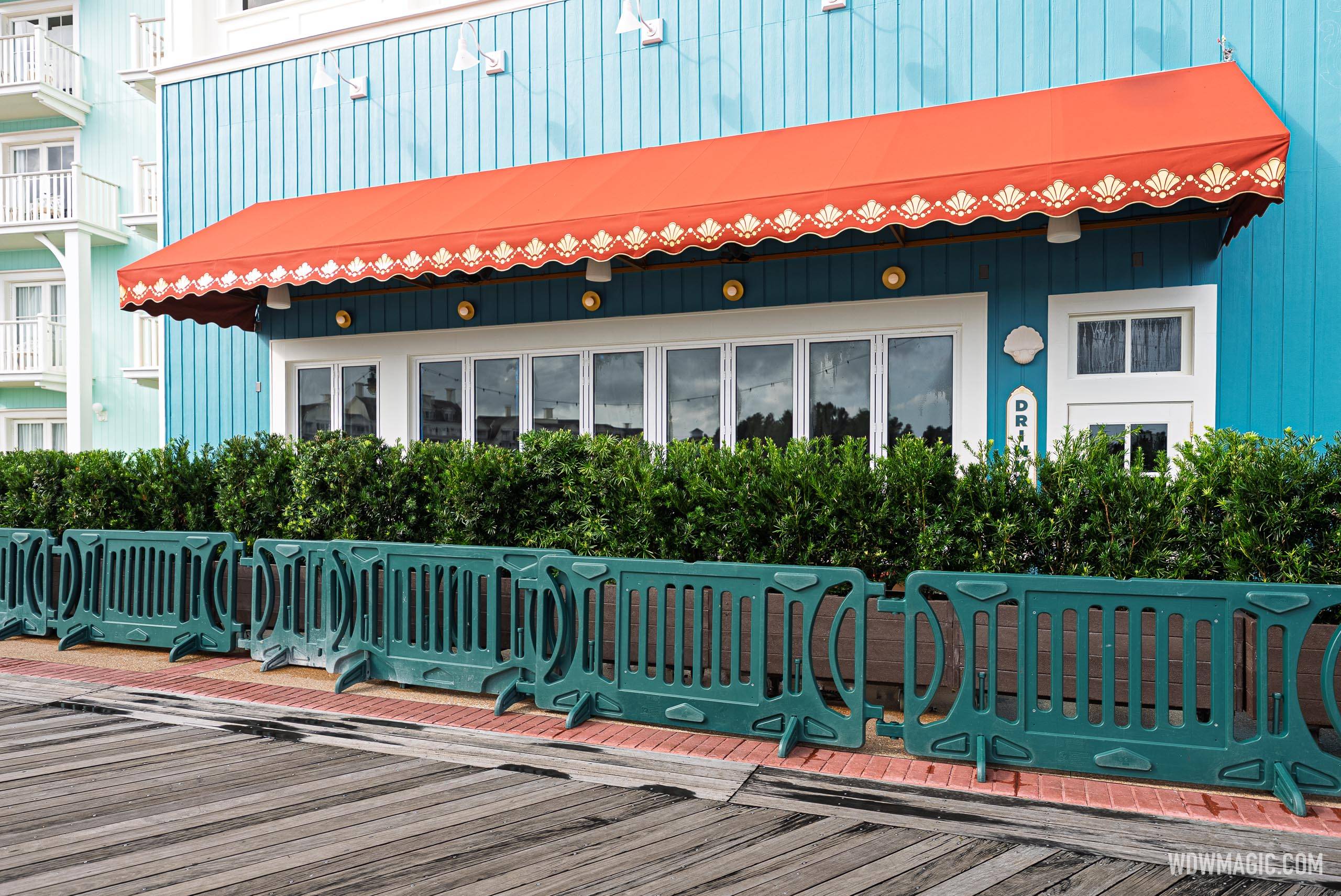 Red awnings with shell trim detail and gold accent lighting line the Hurly-Burly exterior along the BoardWalk