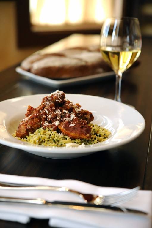 CINNAMON-STEWED CHICKEN: A signature dish at Kouzzina by Cat Cora at Disney’s BoardWalk Resort with tomatoes, herbed orzo and Mizithra cheese. Copyright 2009 The Walt Disney Co.