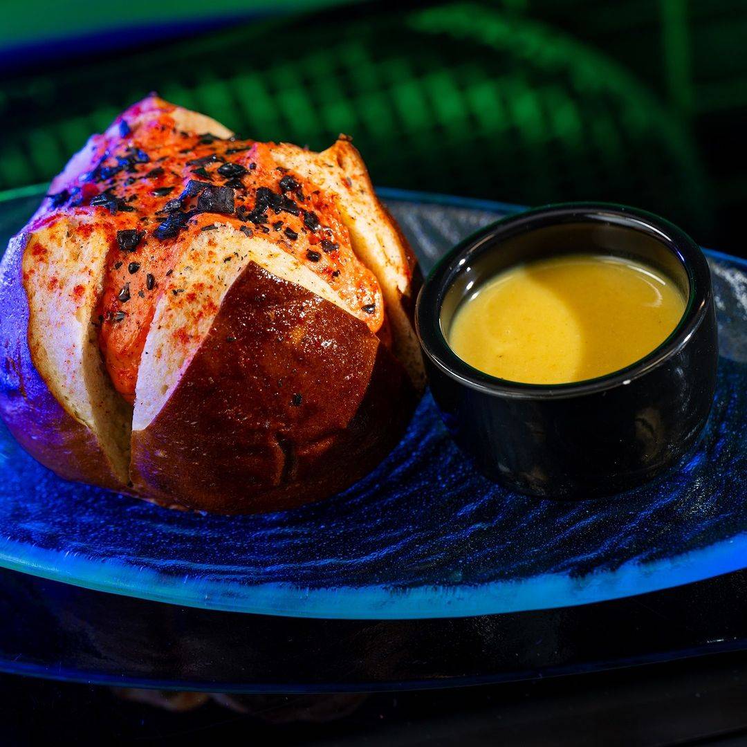 Umbaran Cheese Roll: Spice-dusted pretzel bun stuffed with herbed cheese and a dipping sauce