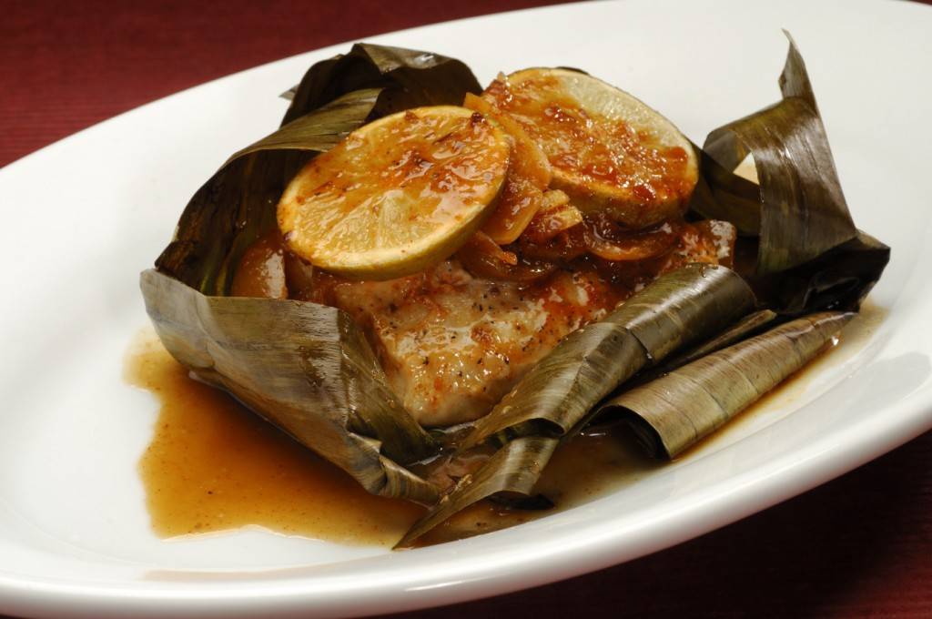 Banana Leaf-wrapped Sustainable Fish with ginger and pickled lime served with basmati rice or seven grain pilag.