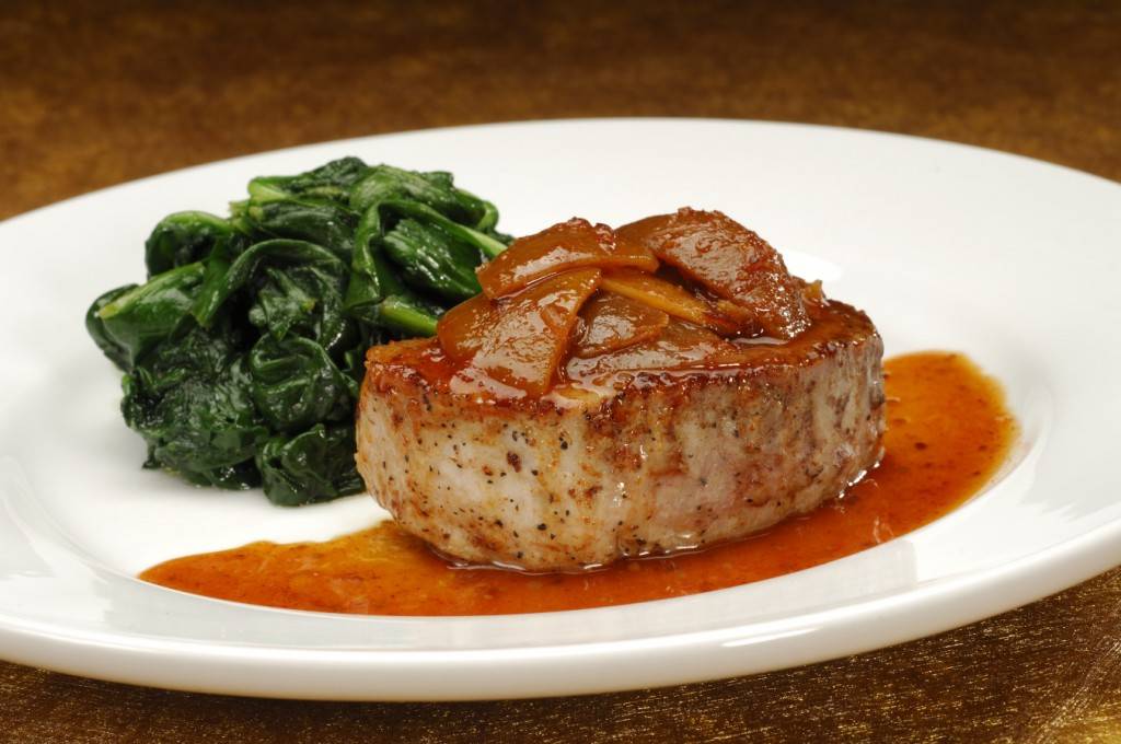 Grilled Pork Chop Loin, glazed with pickled lime and ginger served with sauteed spinach. 