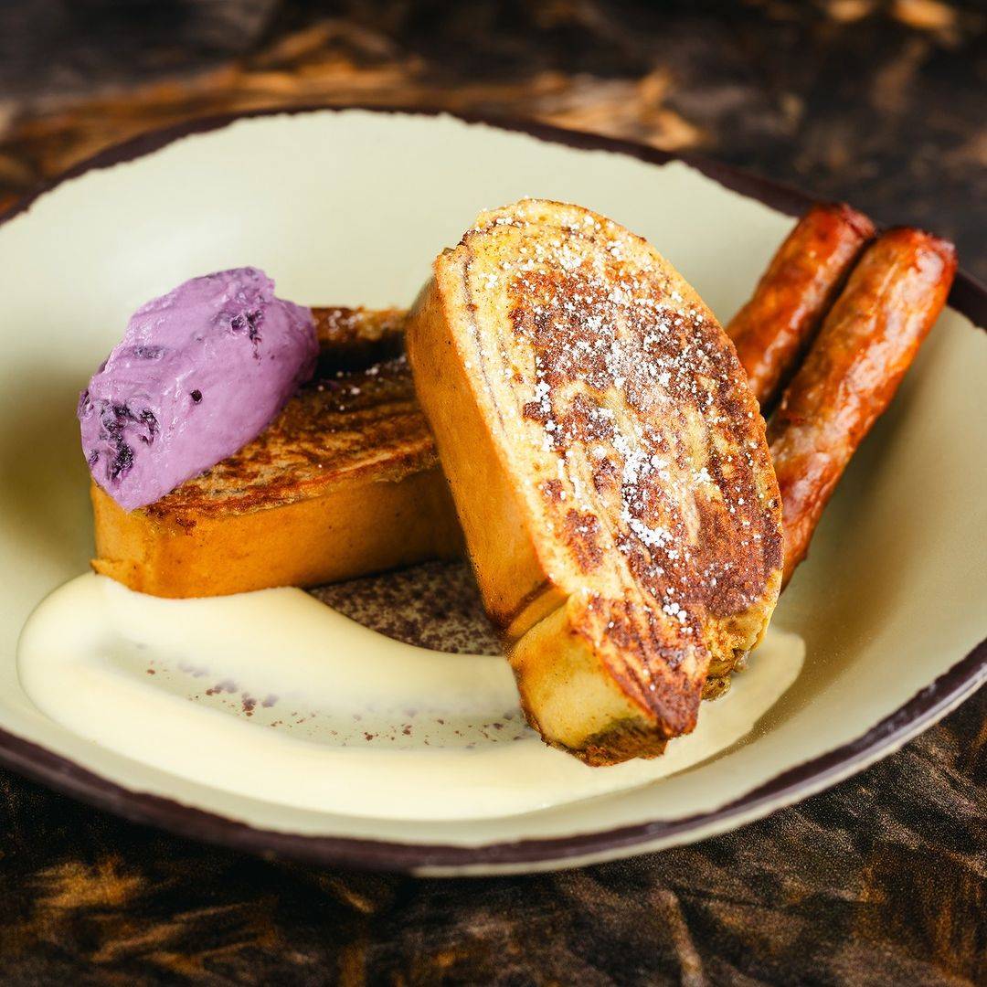 Cinnamon French Toast with blueberry cream cheese, passion fruit anglaise, and sausage