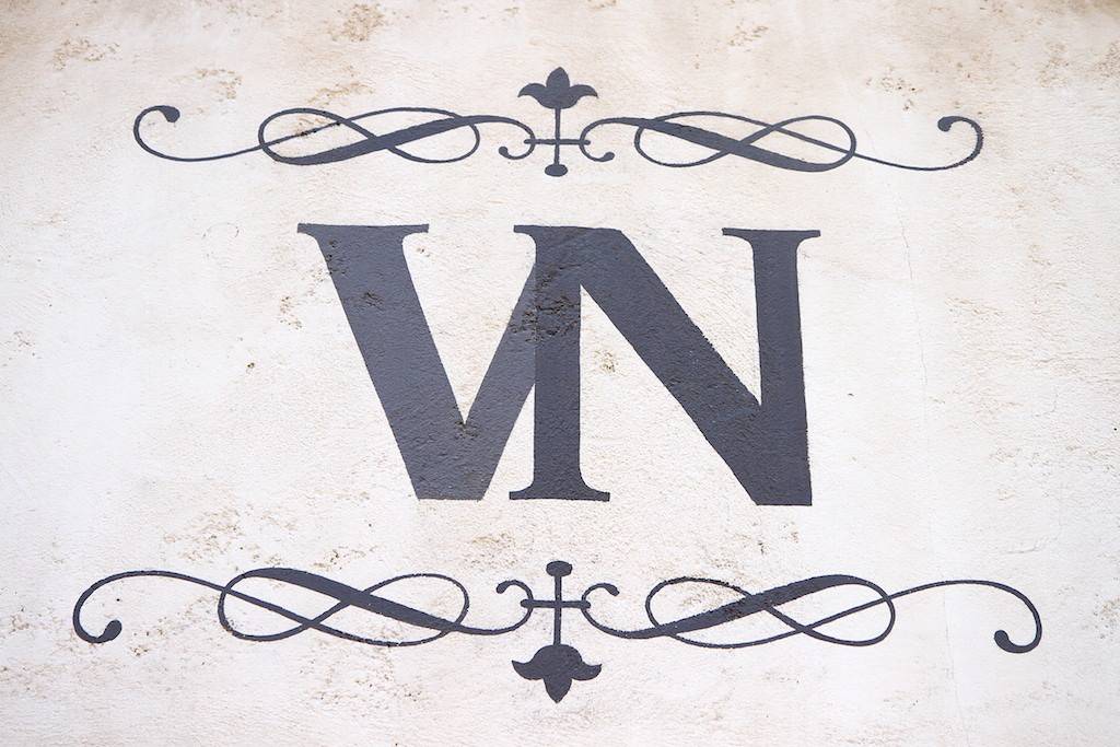 A Via Napoli logo on the exterior of the building