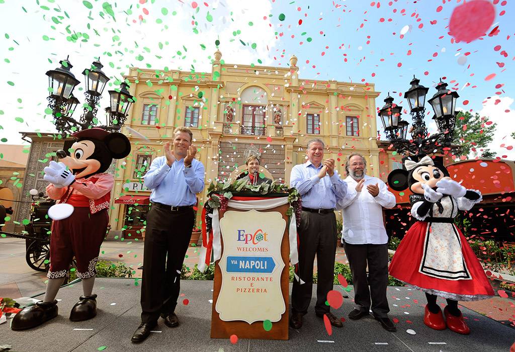 VIA NAPOLI: (L-R) Mickey Mouse; Dan Cockerell, Vice President of Epcot; Clay Shoemaker, Walt Disney World Ambassador; Nick Valenti, CEO of Patina Restaurant Group; Joachim Splichal, Founder and Chairman of Patina Restaurant Group; and Minnie Mouse celebrate Aug. 5, 2010 during the grand opening of Via Napoli in the Italy pavilion at Epcot World Showcase. Via Napoli, operated by Patina Restaurant Group, features wood-burning ovens – and will use water from a source that most resembles the water in Naples, Italy, home of some of the world’s best pizza dough. The 300-seat pizzeria features a menu inspired by the famous pizzerias of southern Italy. The menu also features pastas, salads, sandwiches and Italian wines. (Gene Duncan, photographer) 