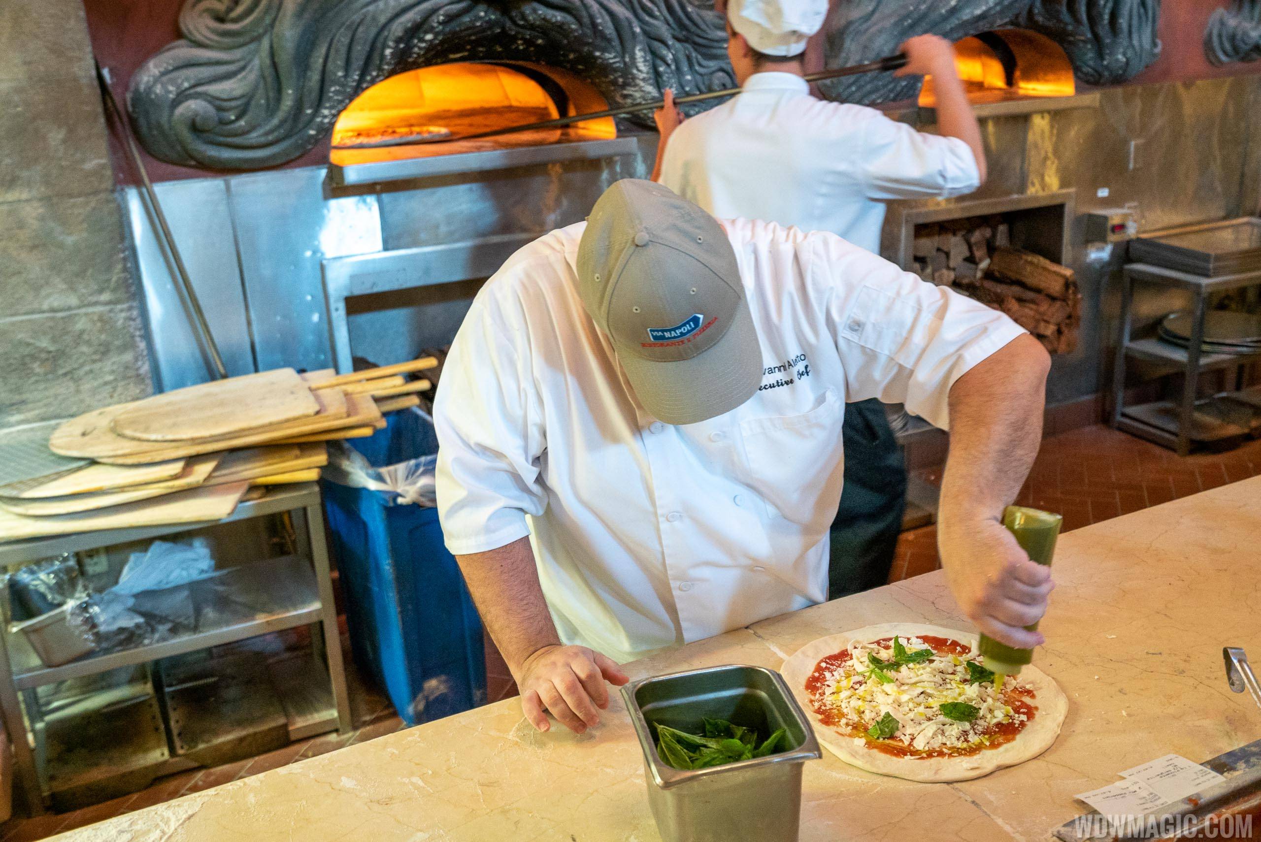 Via Napoli Executive Chef Giovanni Aletto finishes the pizza before it goes to the oven