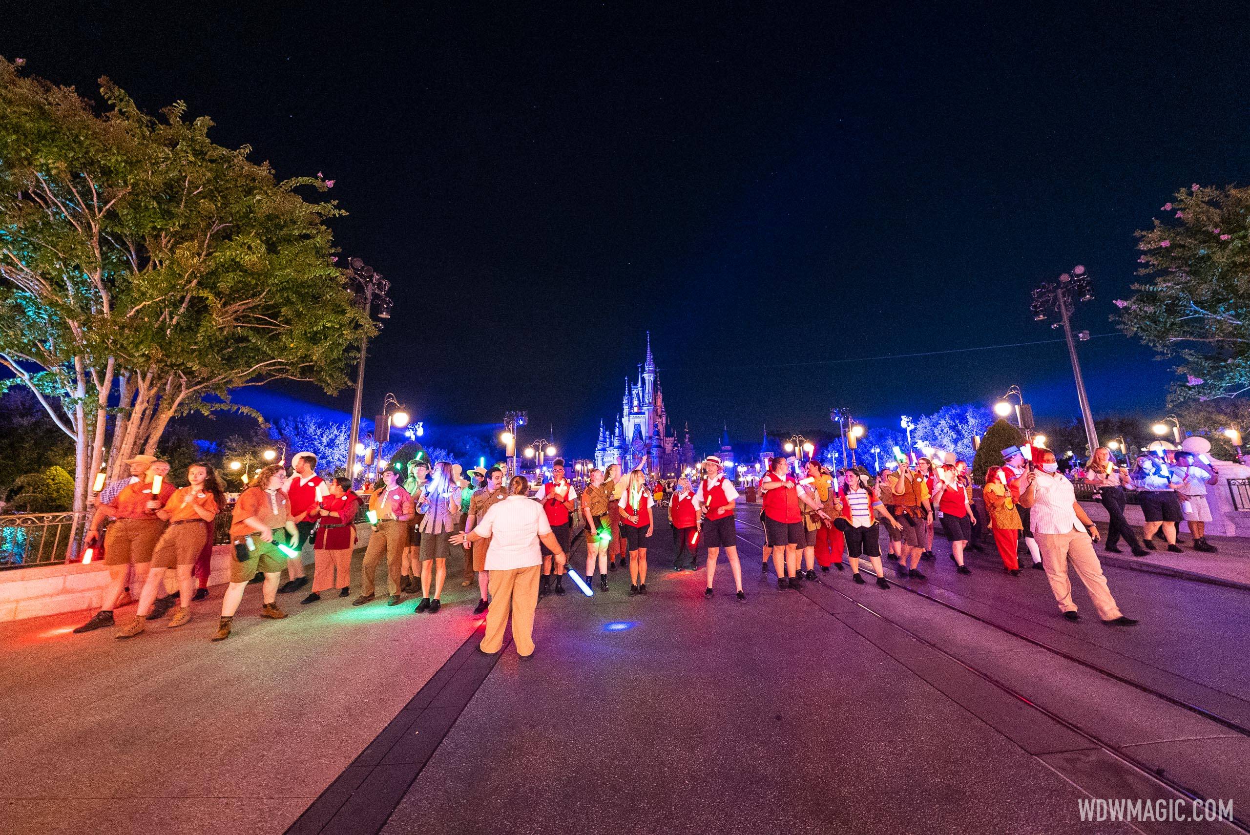 An army of crowd control Cast Members form a human wall to block Main Street from day guests